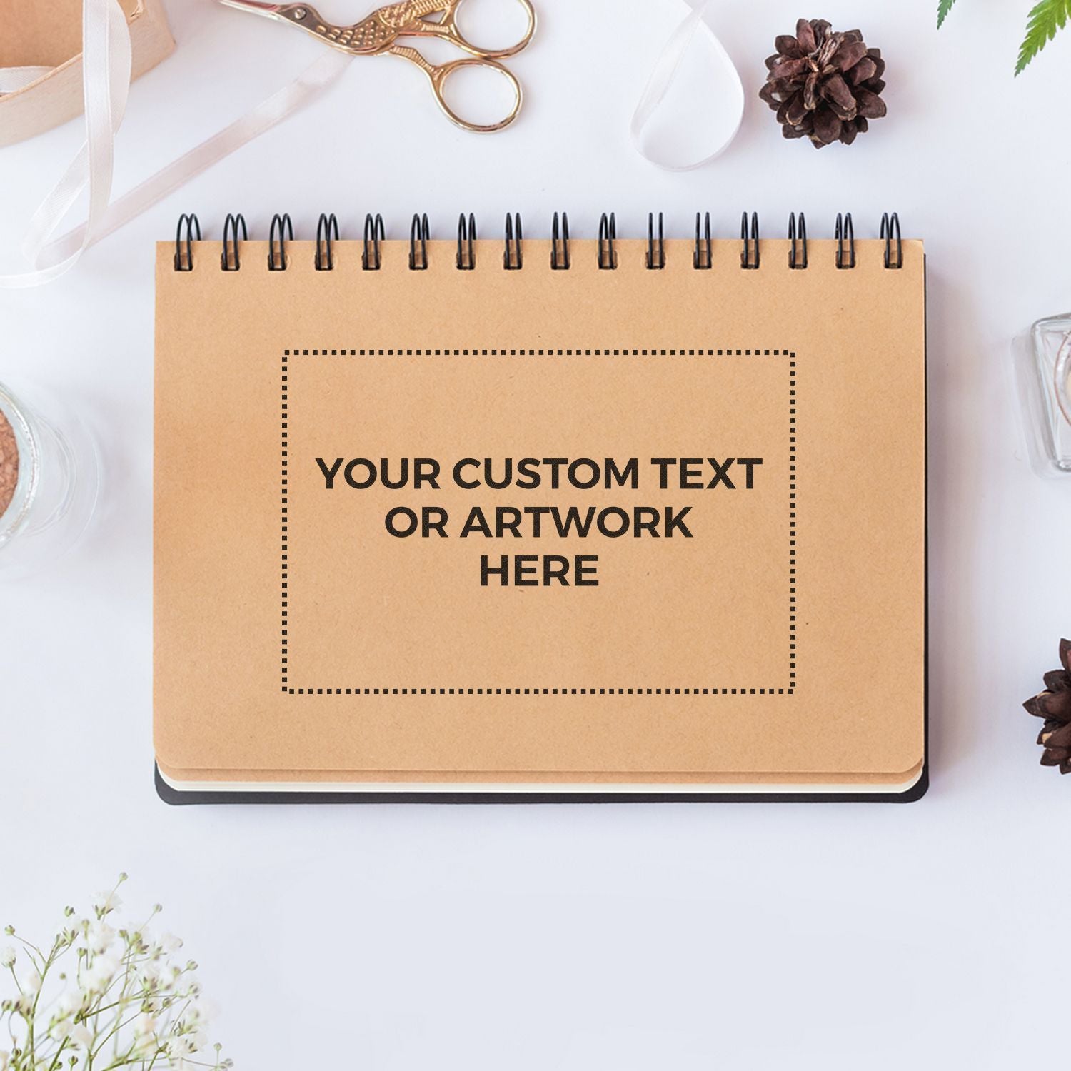 Custom text kraft notebook journal on white desk with scissors and ribbonpersonalized stationery for journaling, DIY crafts, gifts.