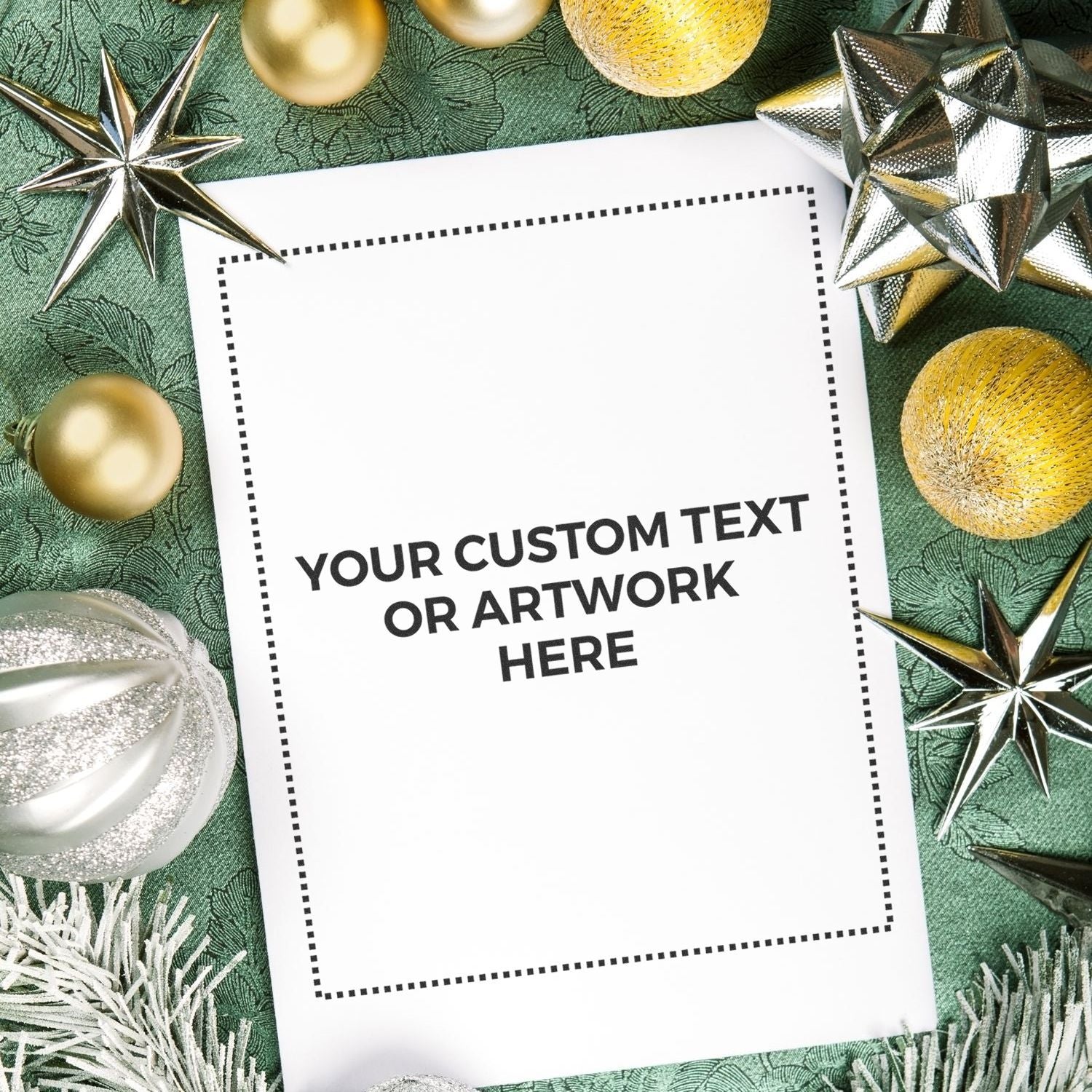 Holiday greeting card template with blank custom text or artwork panel, surrounded by gold and silver ornaments on green fabric.