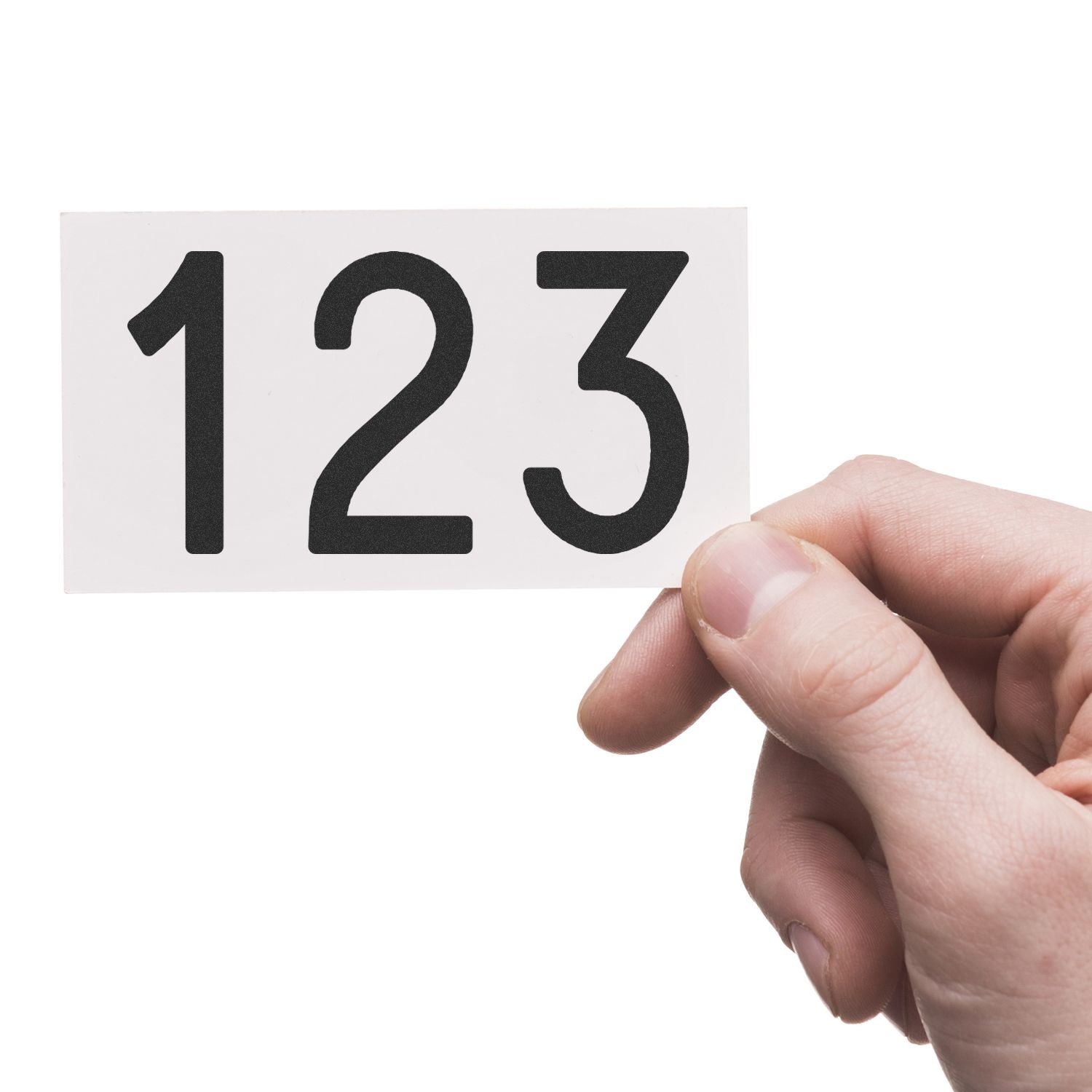 Hand holding a white card with bold black numbers 123 on a white background