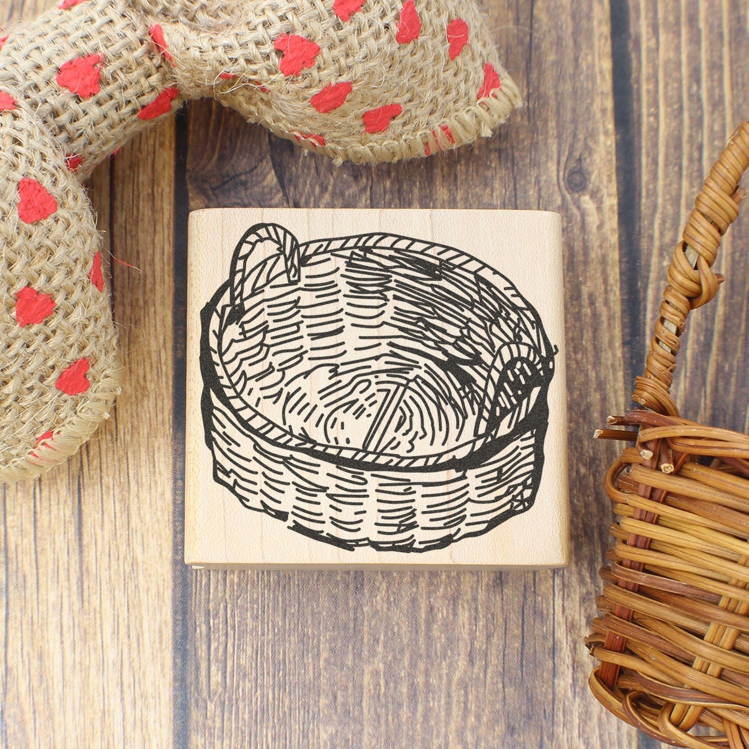 Hand-carved basket rubber stamp on rustic wood background with woven wicker baskets.