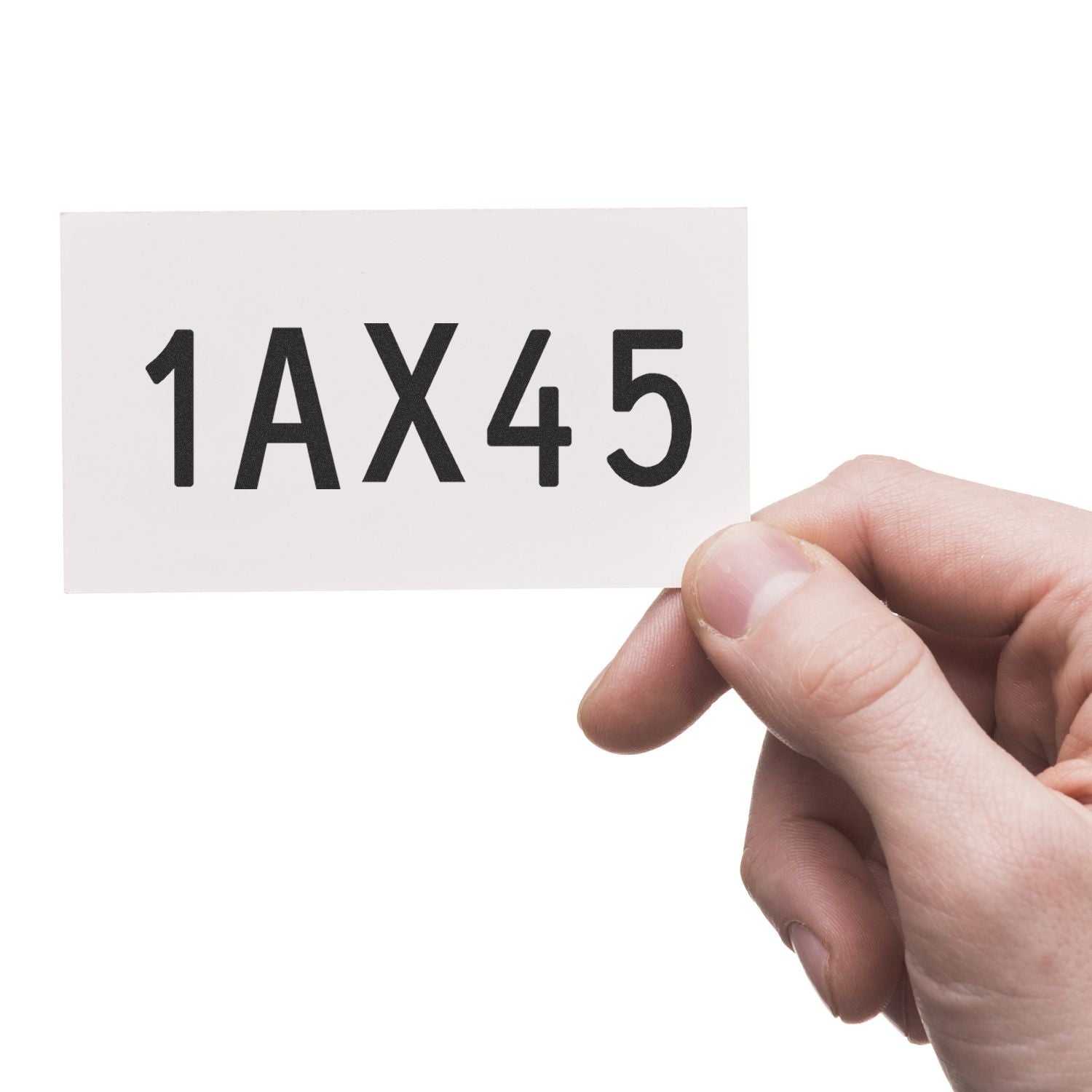 Hand holding white card with bold black 1AX45 code on isolated background.