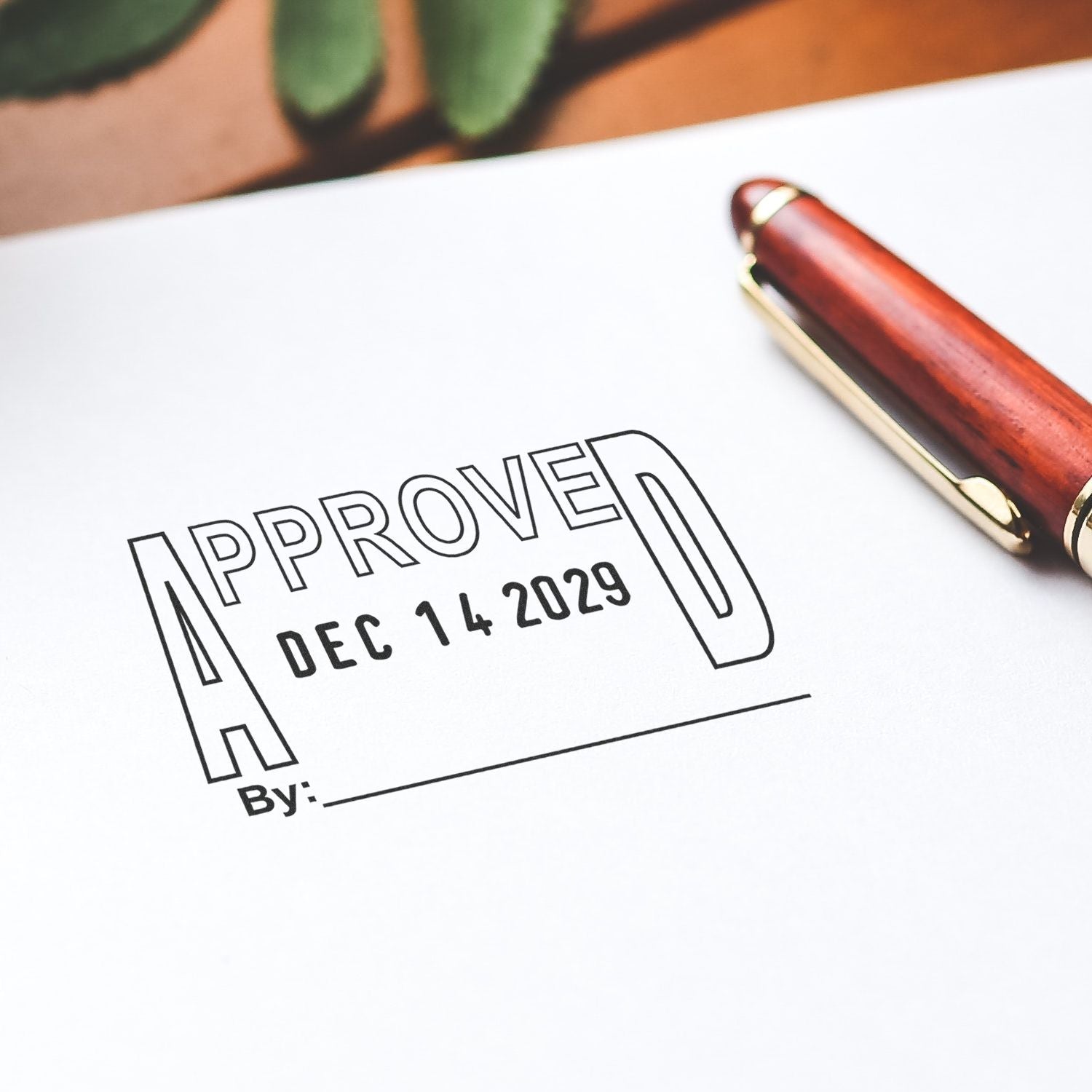 Approved stamp on document with pen, indicating business or legal approval dated Dec 14, 2029.
