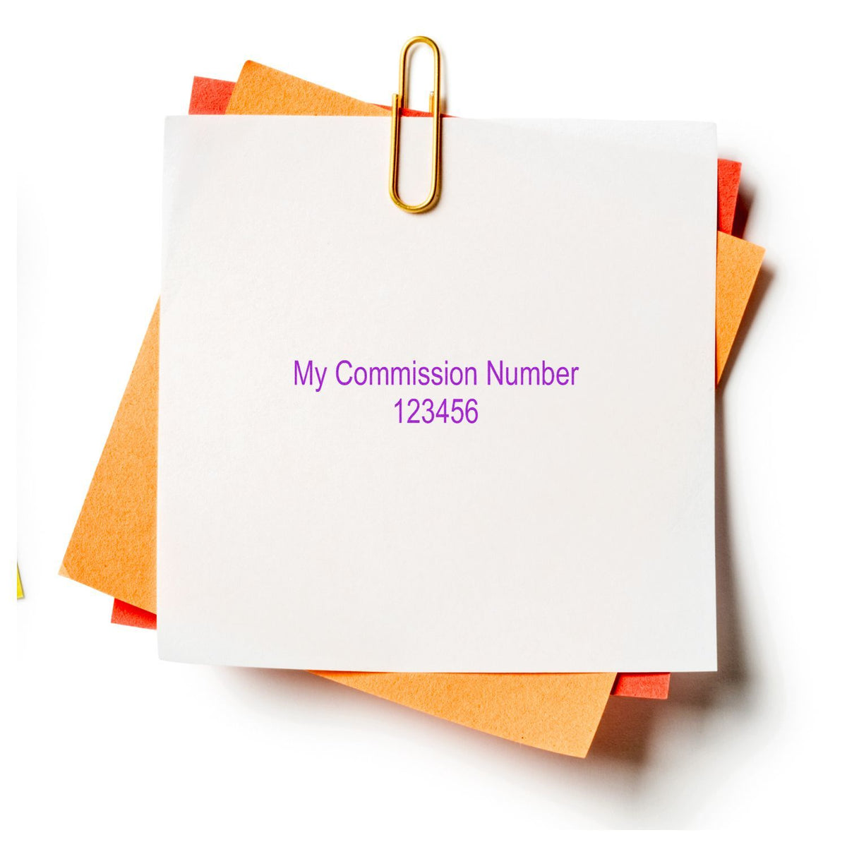 Stack of colorful sticky notes clipped with a gold paperclip, featuring My Commission Number 123456 on a white background.