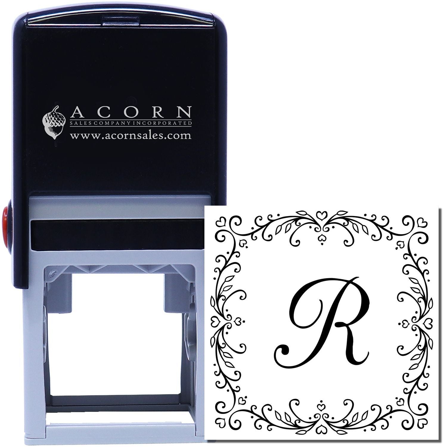Custom self-inking monogram rubber stamp with ornate floral border and letter R for personalized stationery.