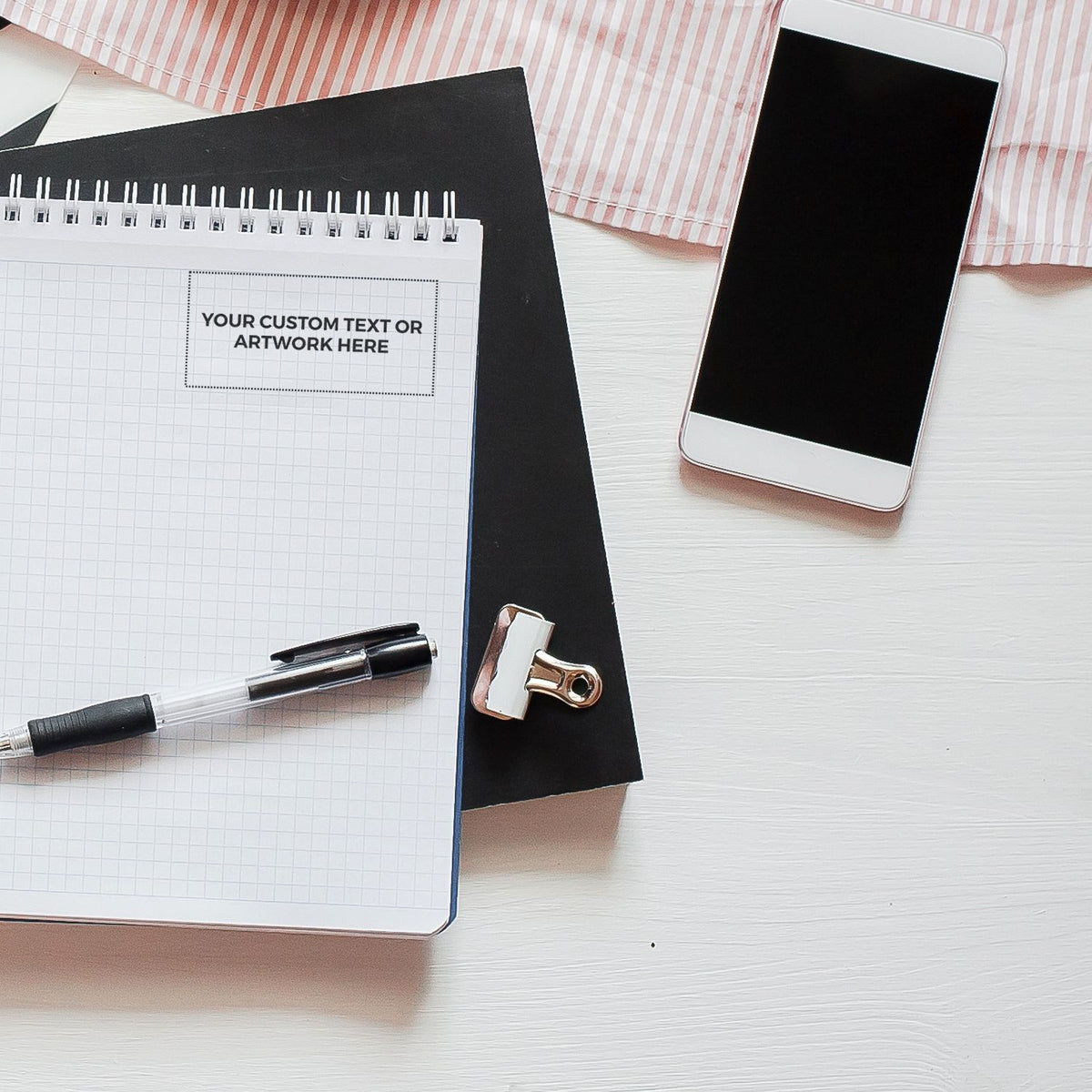 Custom text journal mockup with pen, smartphone, and clipboard on deskpersonalized stationery and brand design template.