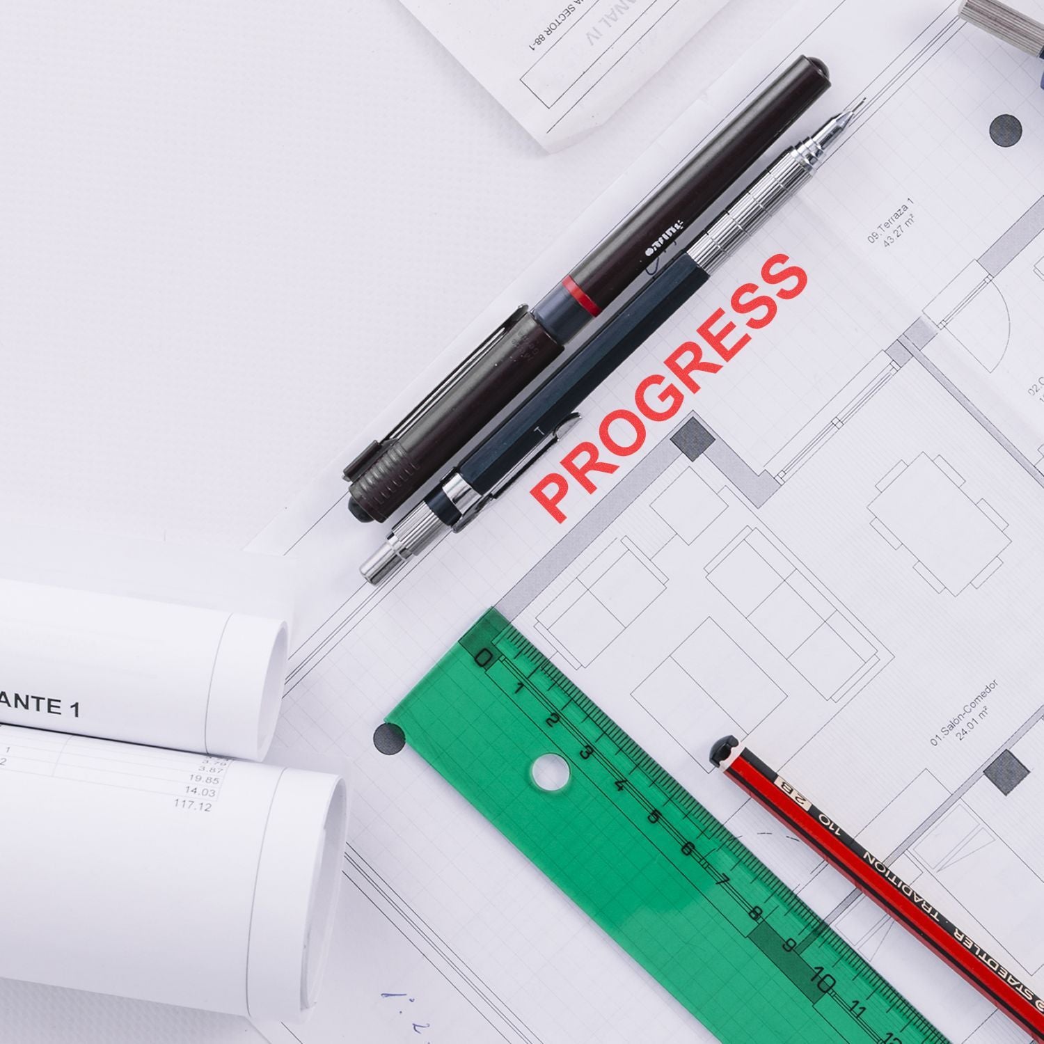 Architectural blueprint with pens, ruler, and progress label, concept for construction planning and project design.