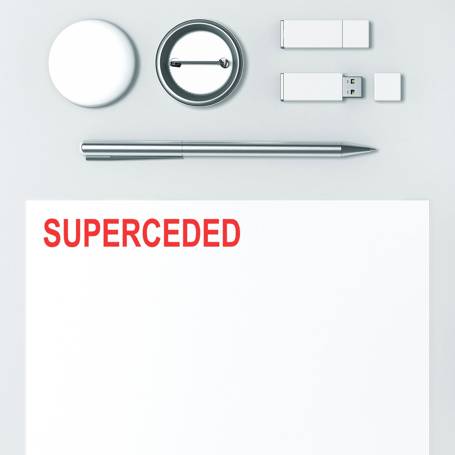 Minimalist office supplies and paper with red SUPERCEDED text on a white background, concept of outdated documents and replacement.
