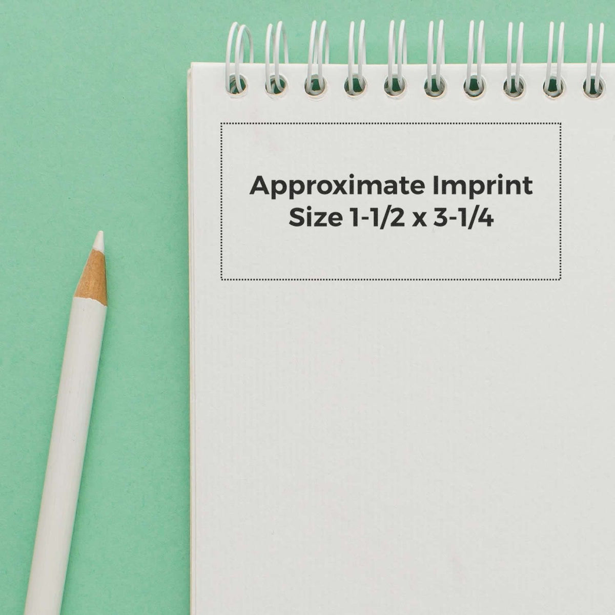 Custom notebook imprint size guide: approximate branding area 1-1/2 x 3-1/4 inches on white spiral notebook with pencil template.