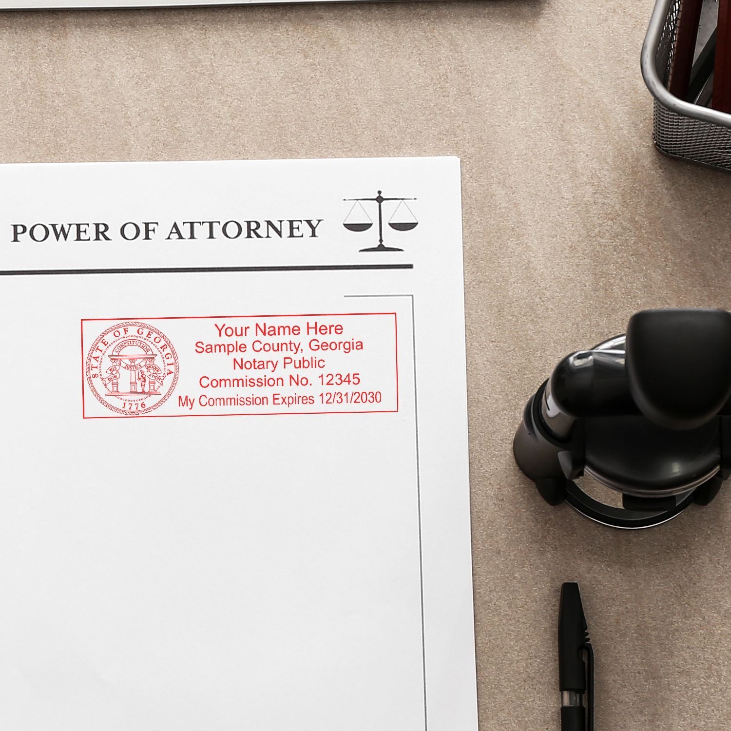 Power of attorney document with Georgia notary public stamp and office desk accessories, legal form for notarization and estate planning.