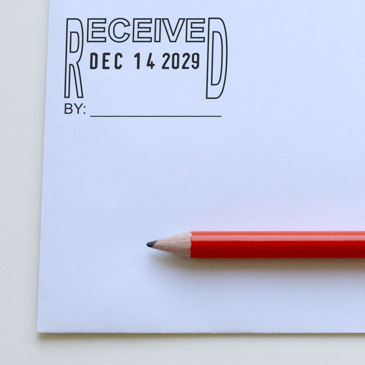 Bullet journal page with decorative Received lettering, Dec. 14, 2029 date, blank byline, and red pencil on white notebook paper.