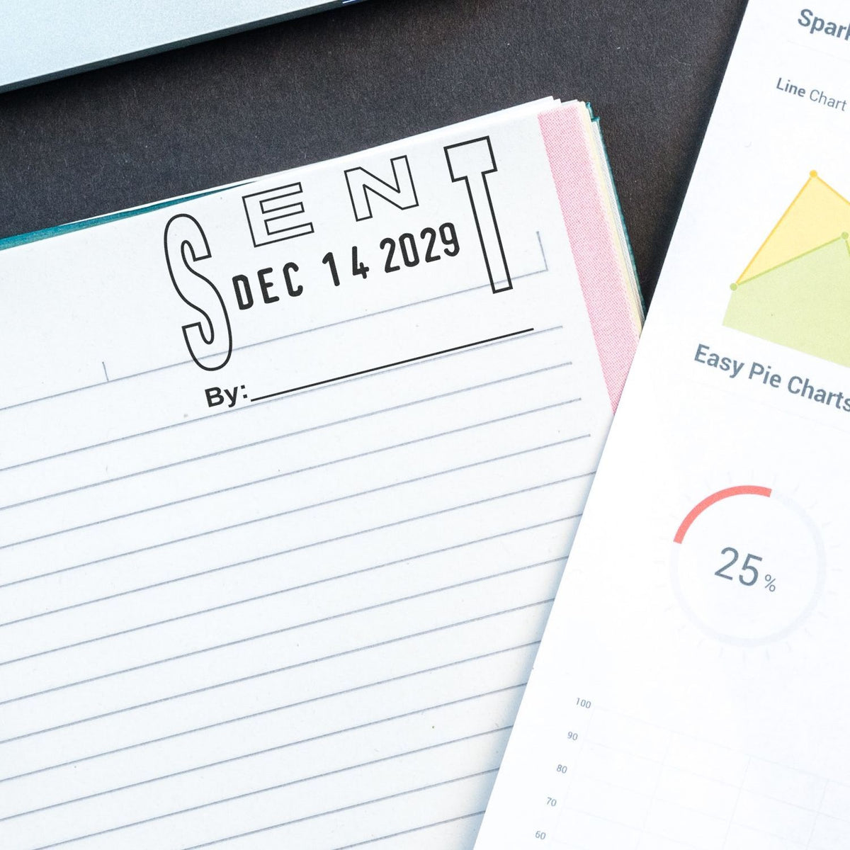Close-up of a Scent notebook with date Dec 14, 2029, beside data chart sheets and pie chart graphics on a desk.