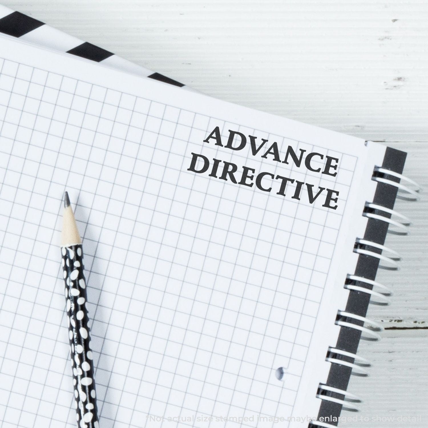 Advance directive document on a lined notepad with pen and binder rings, highlighting healthcare planning and end-of-life wishes.
