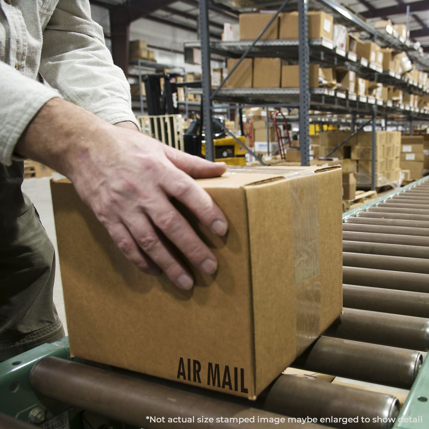 Warehouse worker placing an air mail shipping box on a conveyor belt in a distribution center.