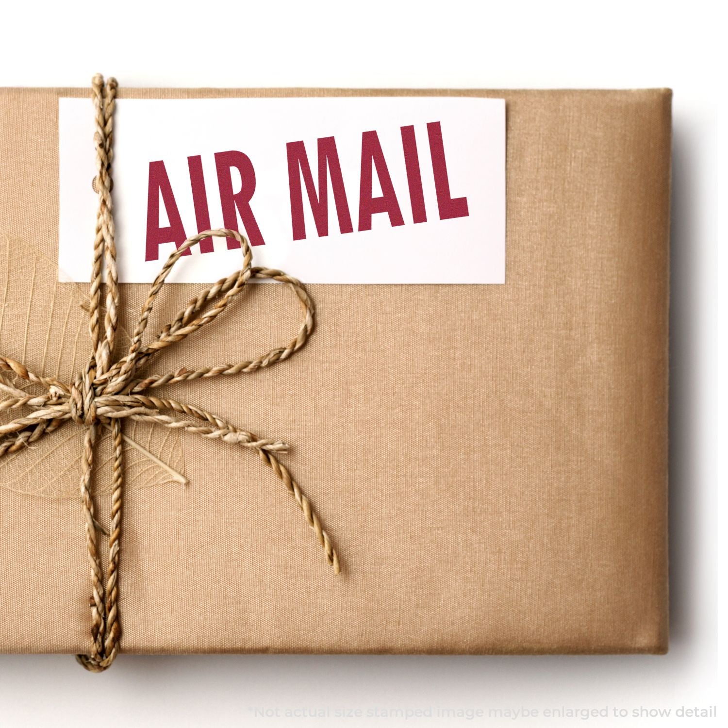 Brown wrapped package tied with twine and MR MAIL label, ideal for postal delivery, shipping, and gift services.
