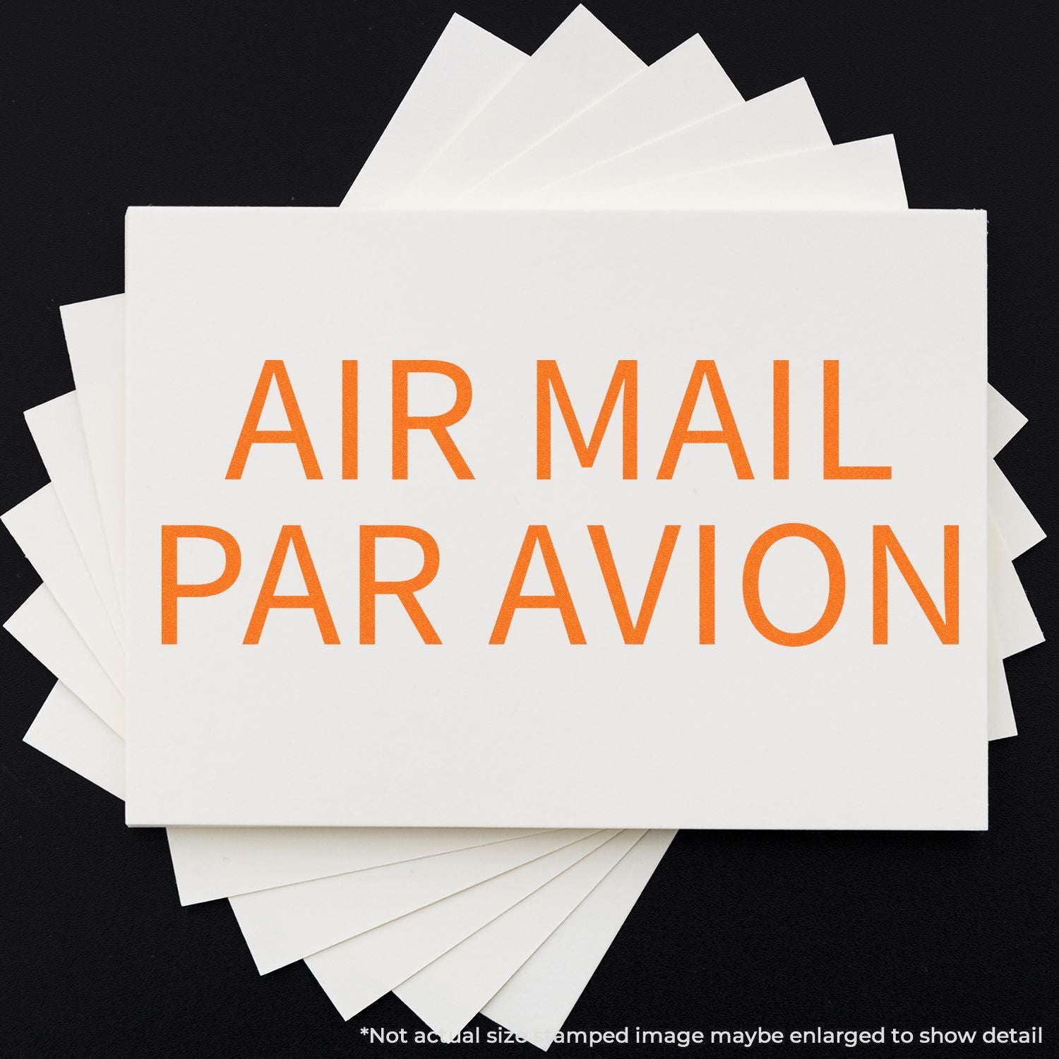 Air mail shipping card showing orange AIR MAIL PAR AVION text on stacked white sheets over dark background for international mail.