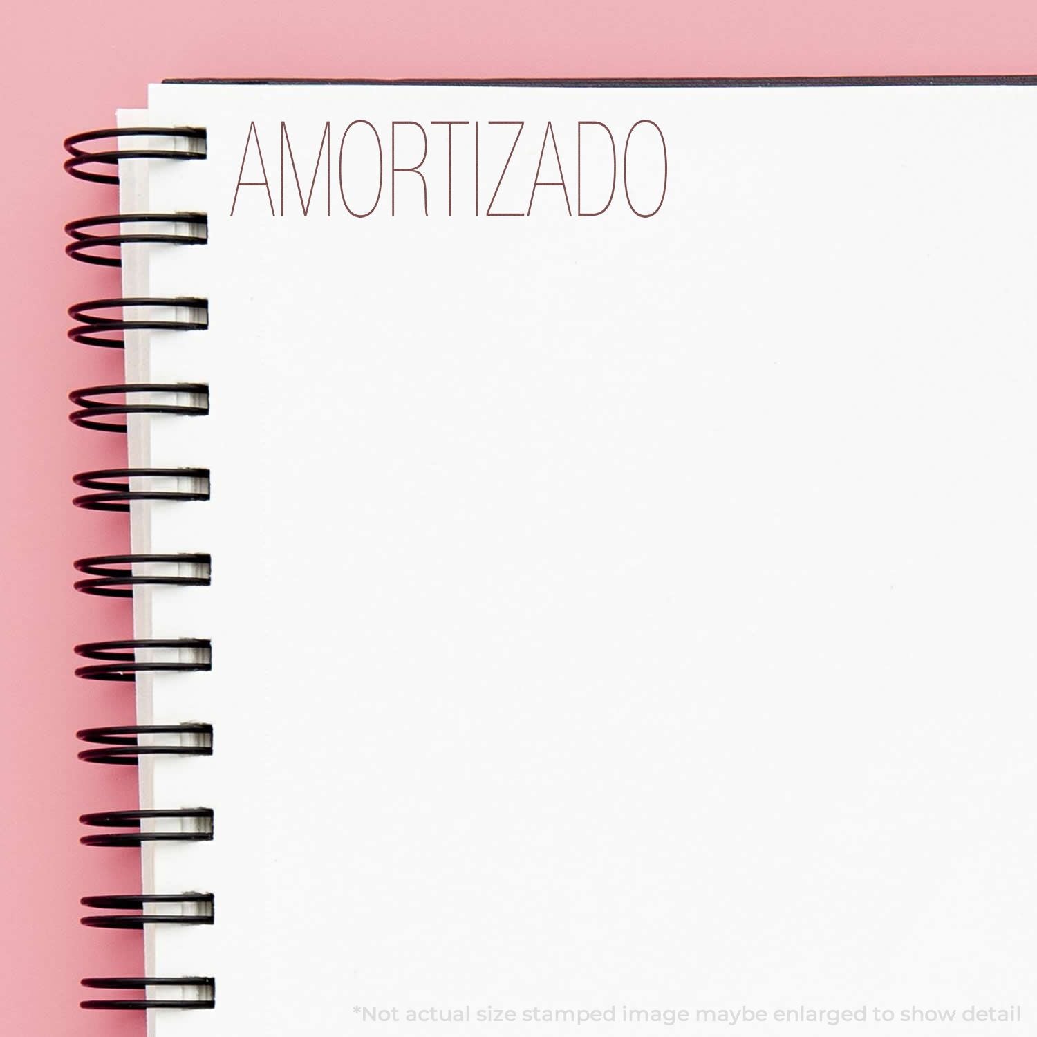 AMORTIZADO printed on a spiral-bound notebook, ideal for amortization and budgeting notes organization.