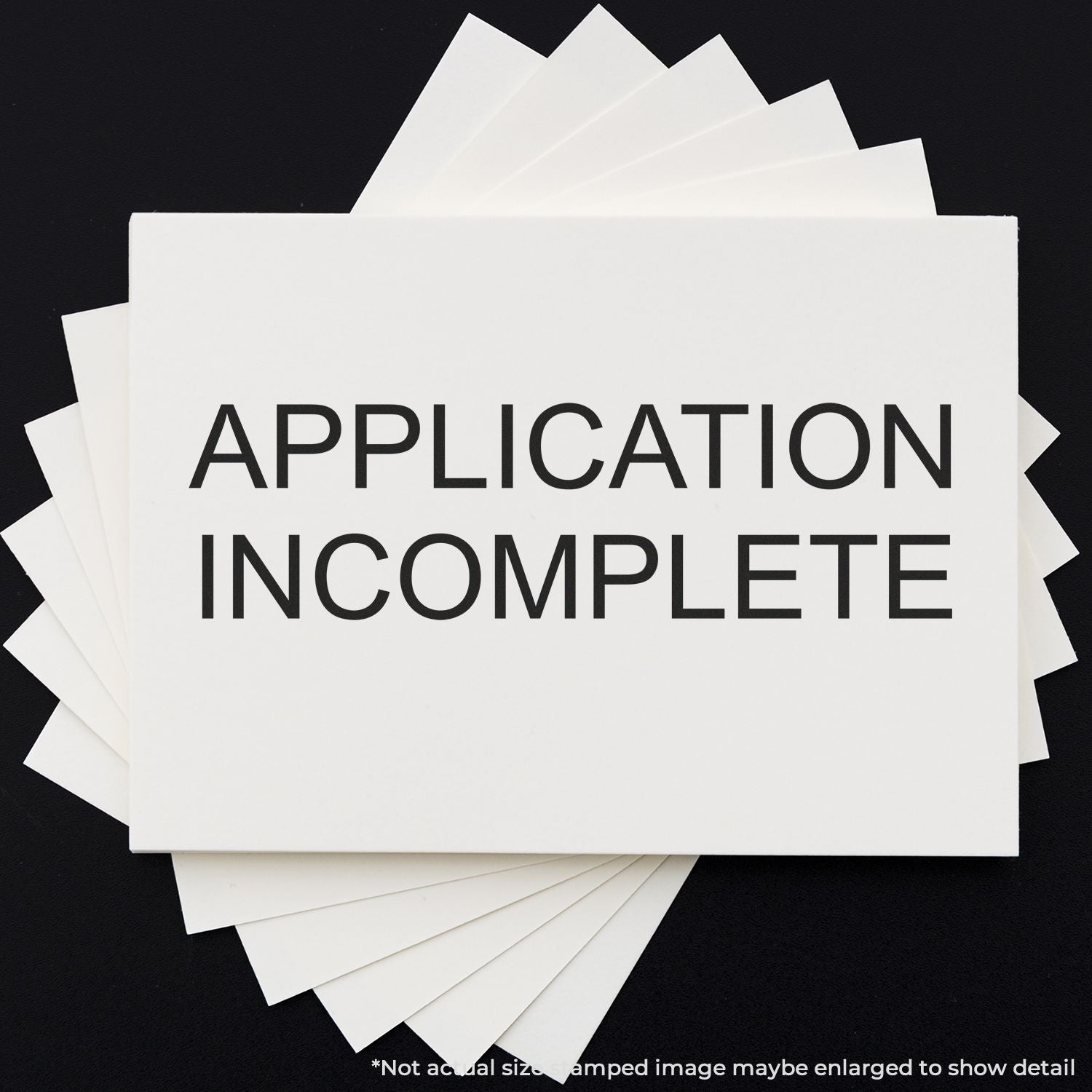 Application incomplete message on a stack of application forms, highlighting missing information for submission or review.