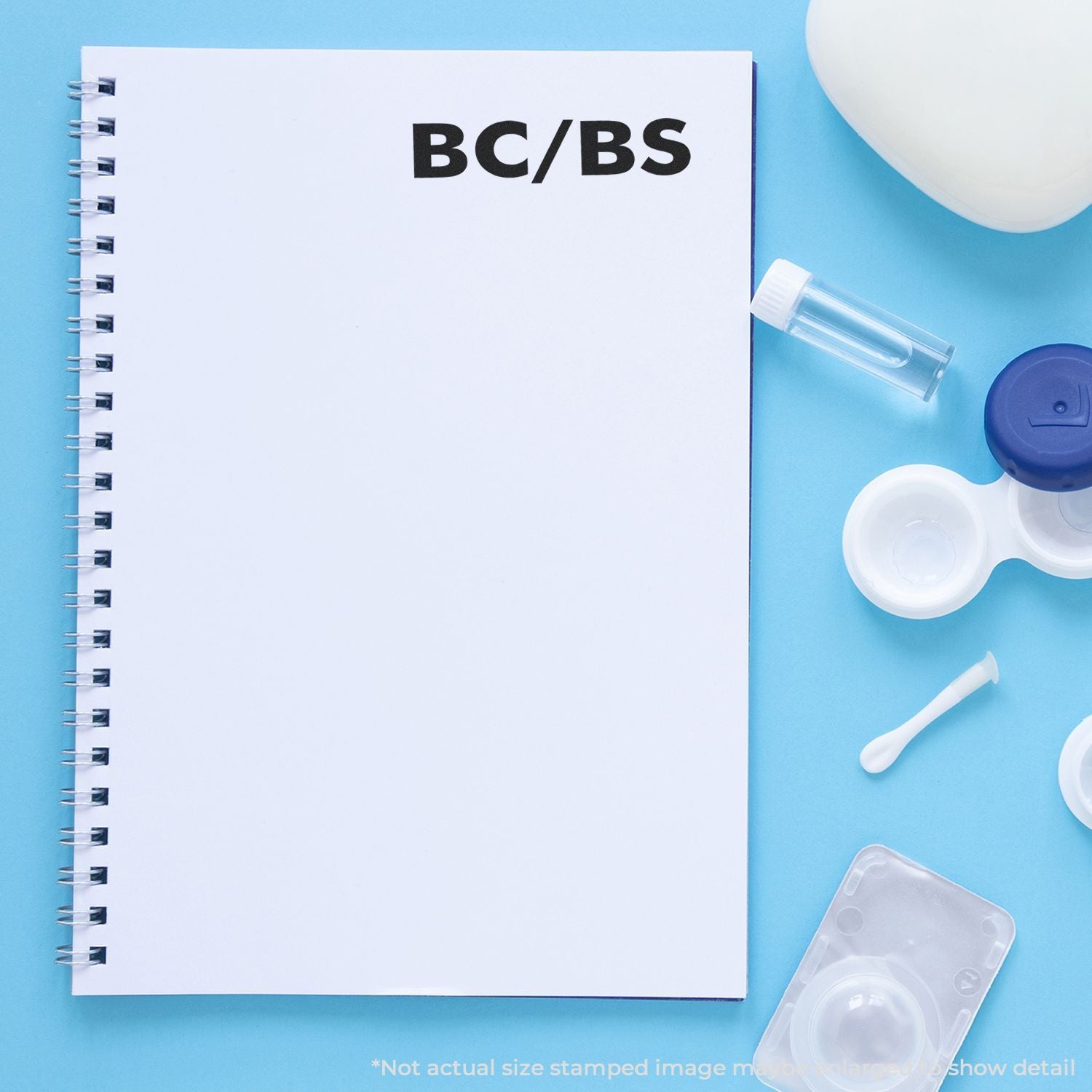 Notebook labeled BC/BS with medical supplies on blue background, representing Blue Cross Blue Shield health insurance coverage.