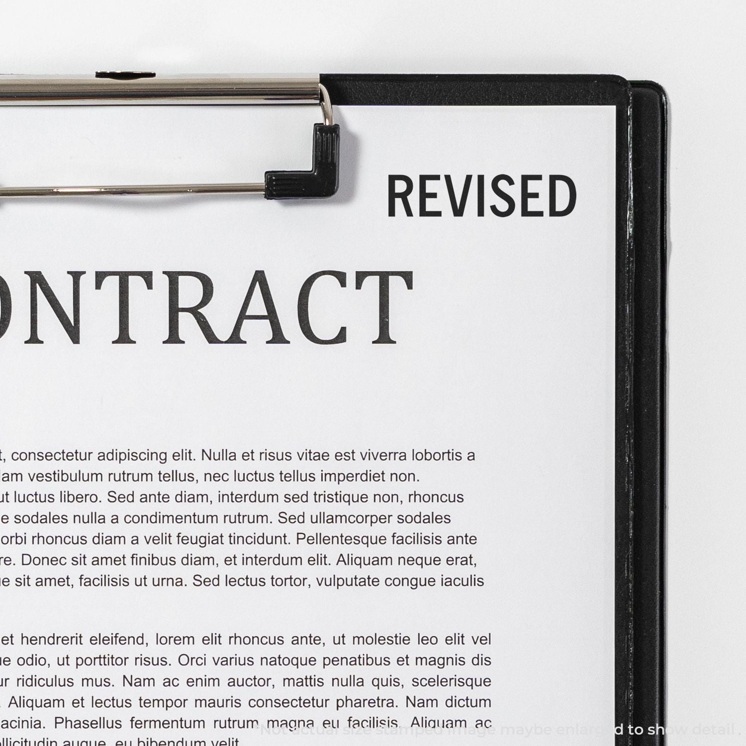 Revised document on clipboard with REVISED stamp, highlighting edited paperwork and proofread changes for publication.