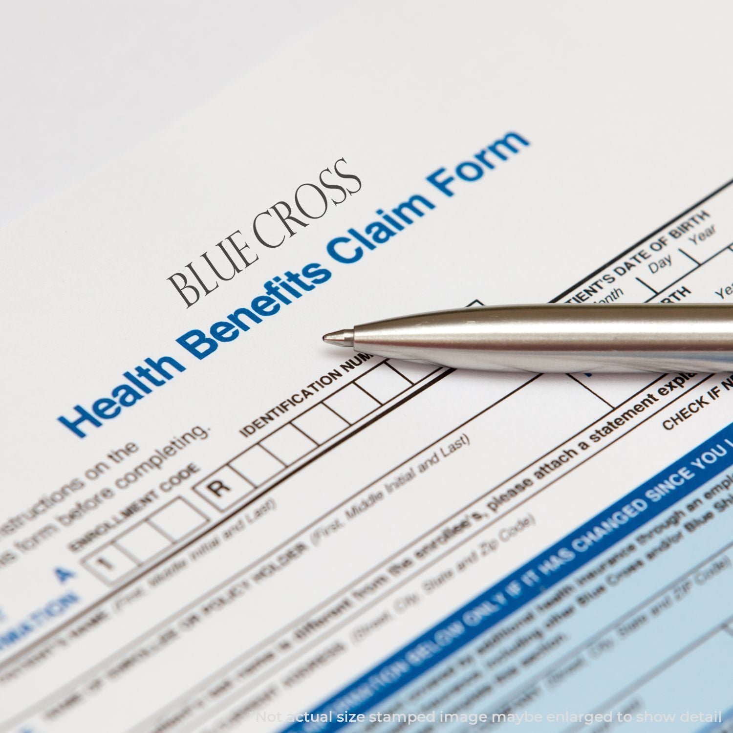 Blue Cross health benefits enrollment form with identification section and pen, highlighting health insurance application details.