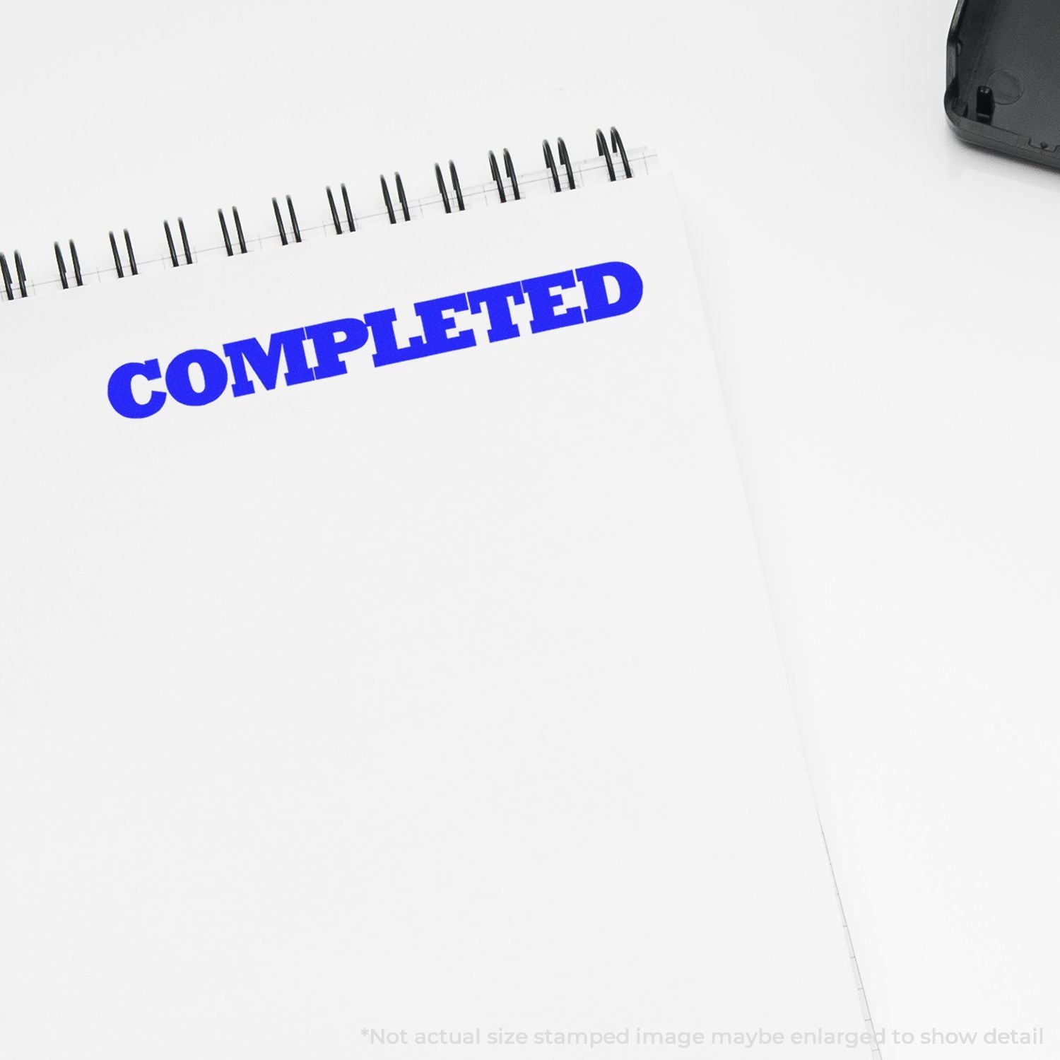 Blue COMPLETED stamp on a planner notebook, showing task completion status for workflow, compliance tracking, and productivity.