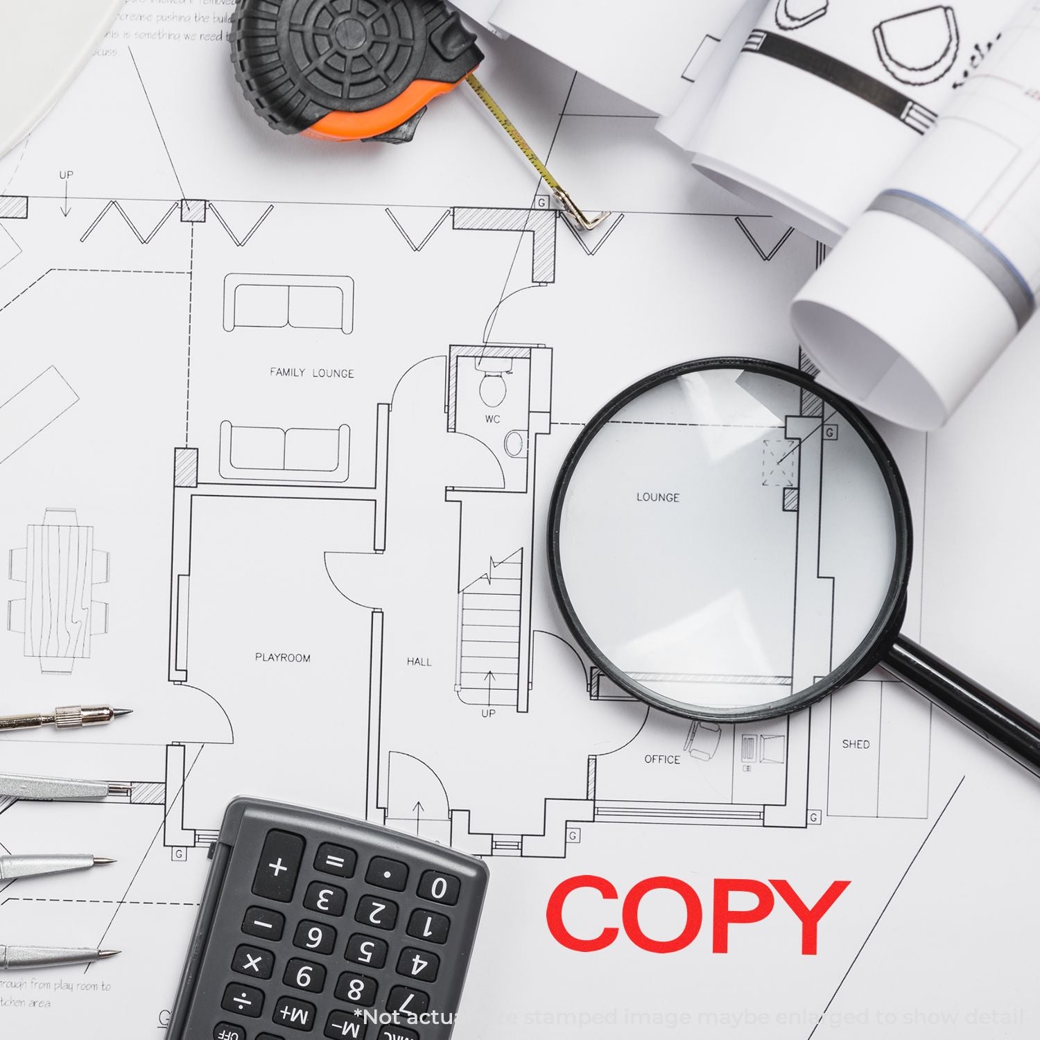 Architectural floor plan copy with calculator, measuring tape, magnifying glass and 'COPY' stamp for estimating home renovations.
