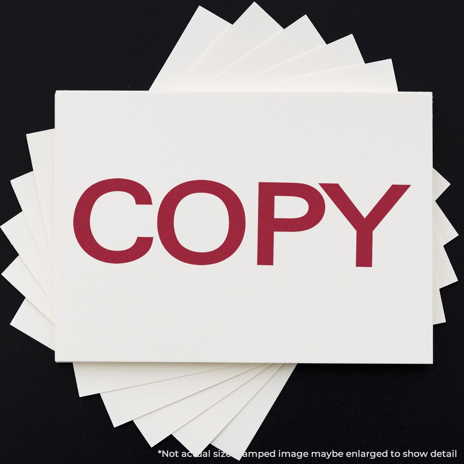 Stack of white printing cards with red COPY text, illustrating copying and print services on a black background.