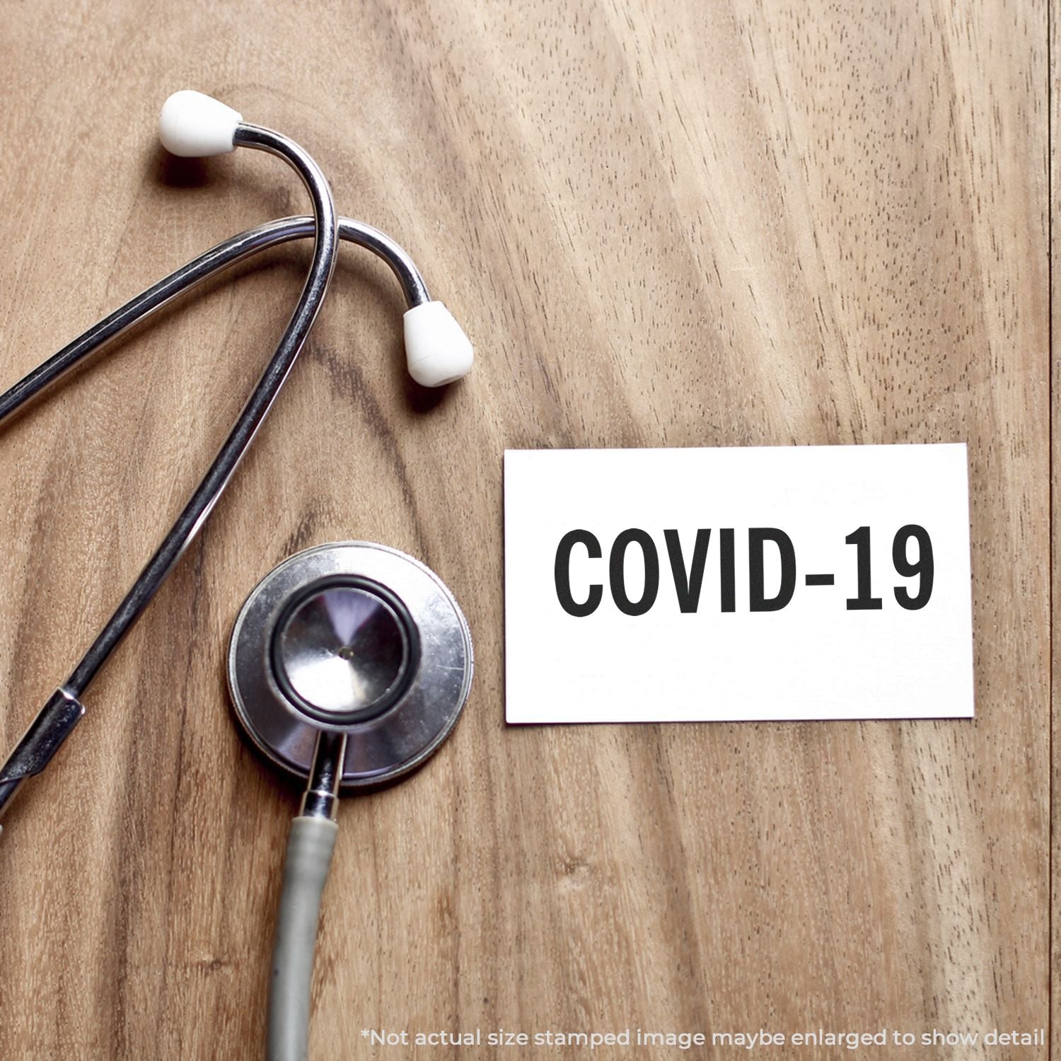 Stethoscope beside COVID-19 warning card on wooden background, highlighting healthcare screening and coronavirus awareness.