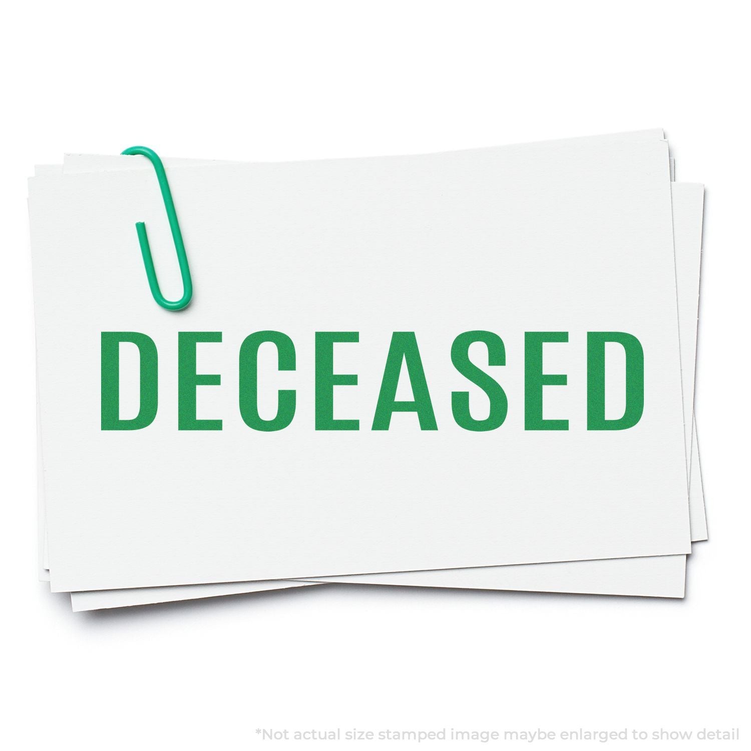 Deceased green text on stacked white papers with paper clip, isolated on white background.