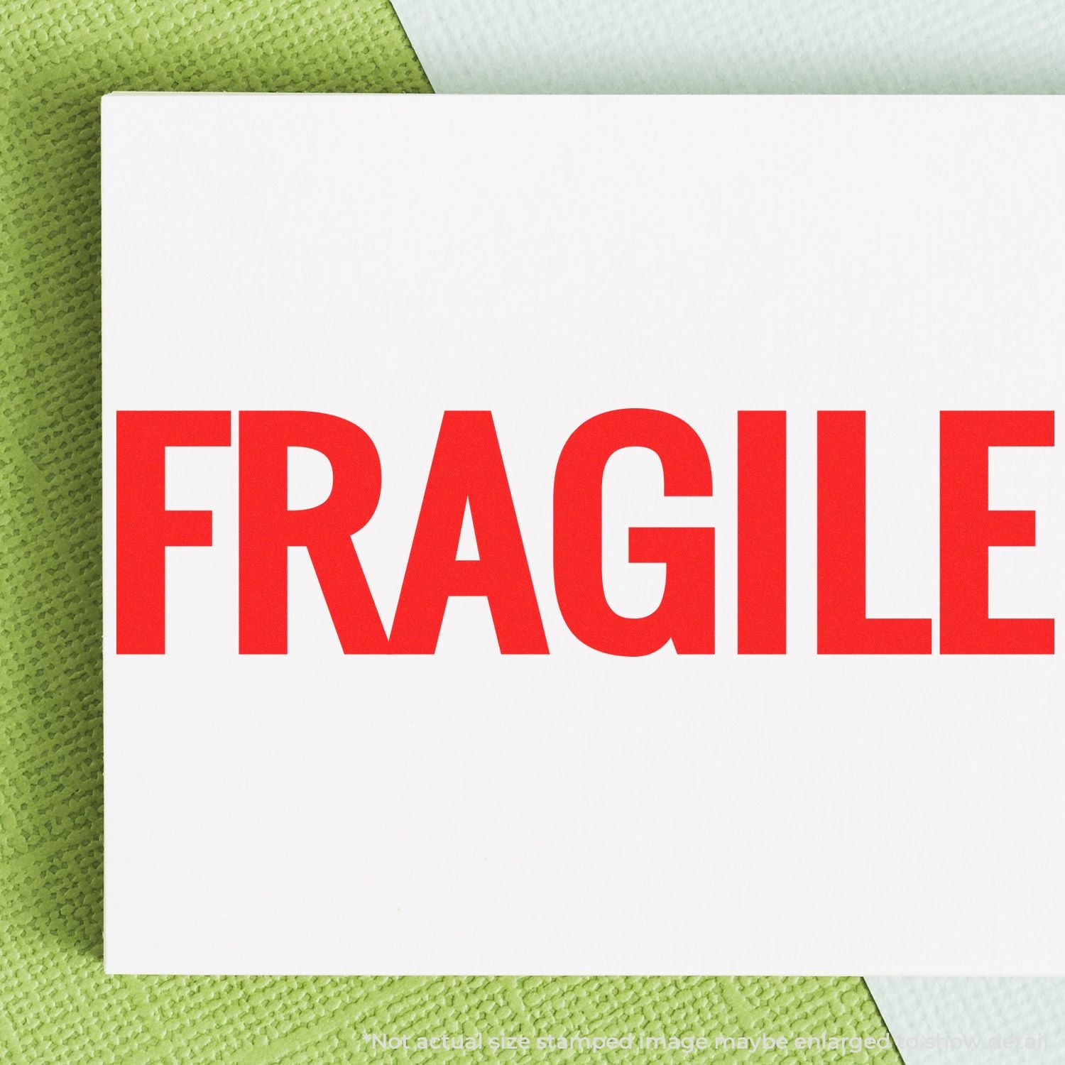 Bold red FRAGILE label on white card for shipping and fragile package warning.