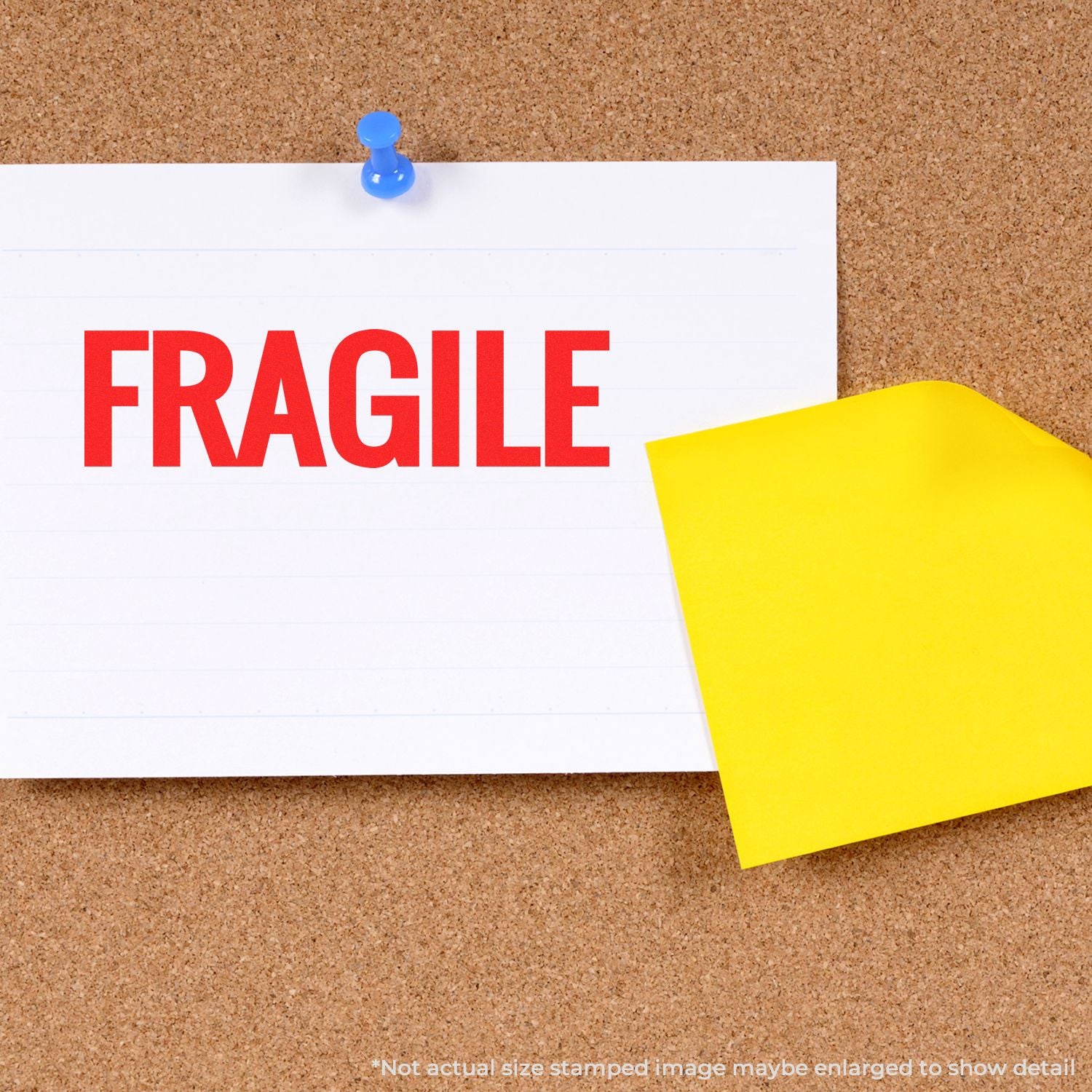 Red FRAGILE shipping warning on a white paper pinned to a corkboard with a blue pushpin and yellow sticky note.