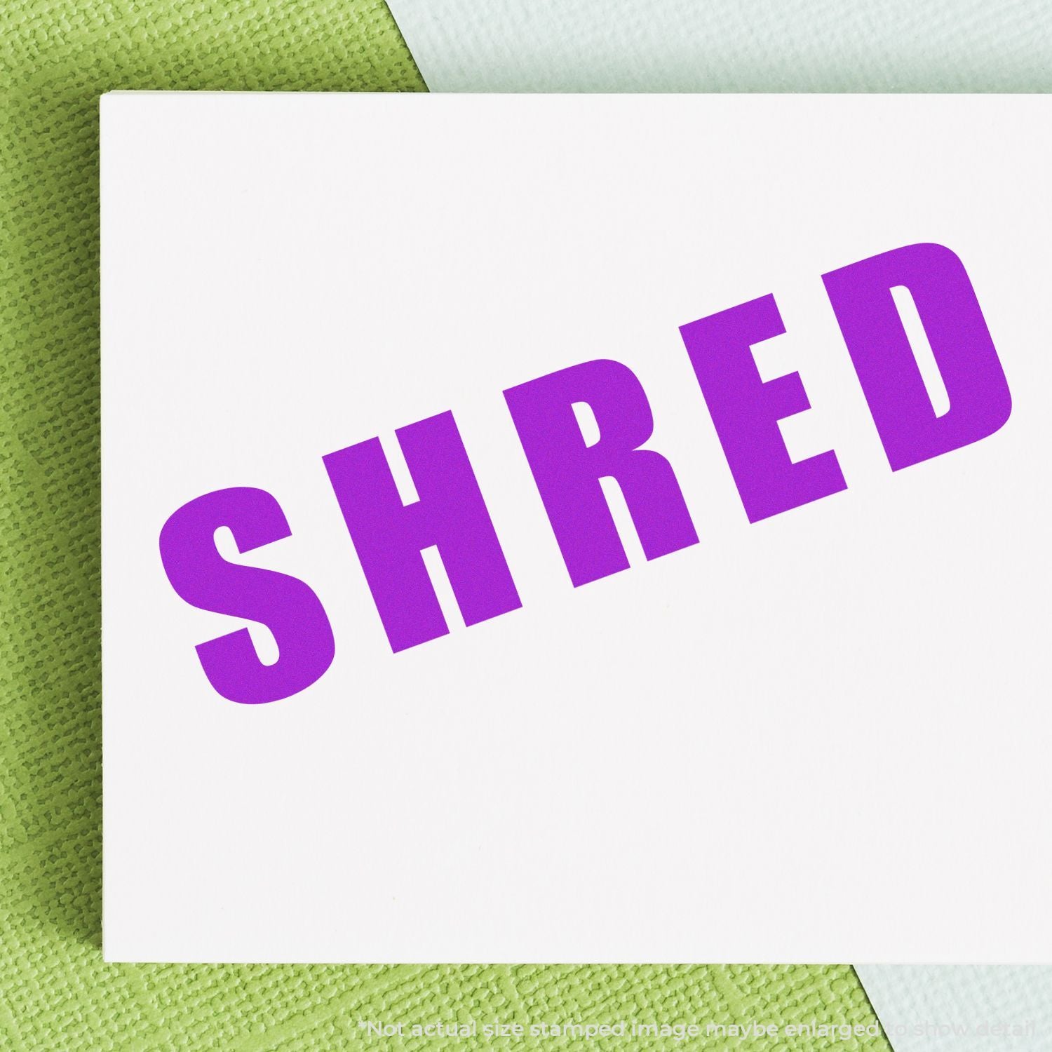 Purple STRED typography on a white paper card over a green textured background, showcasing graphic design lettering.