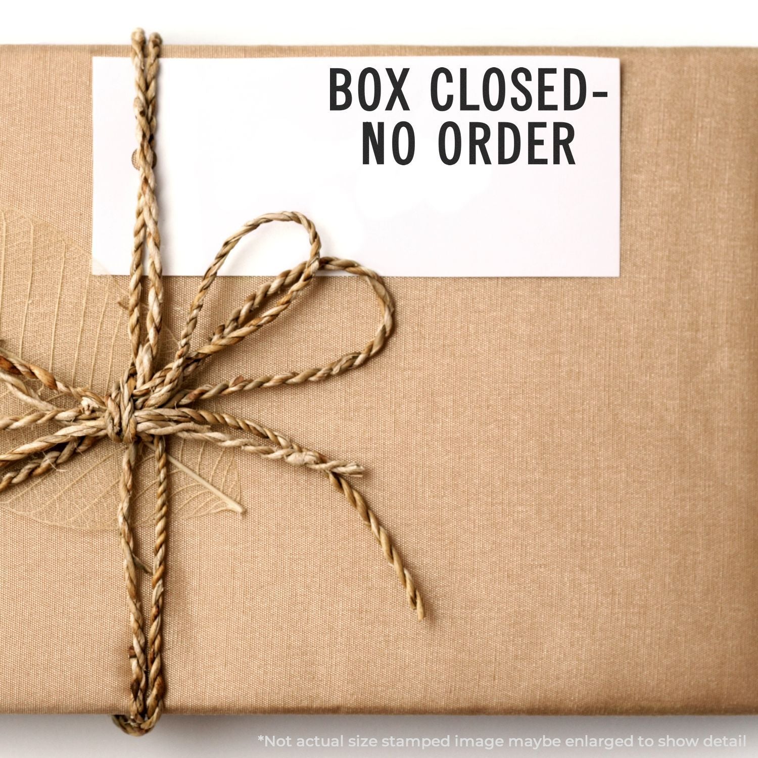 Wrapped gift box with twine and Box Closed No Order sign on kraft paper packaging.