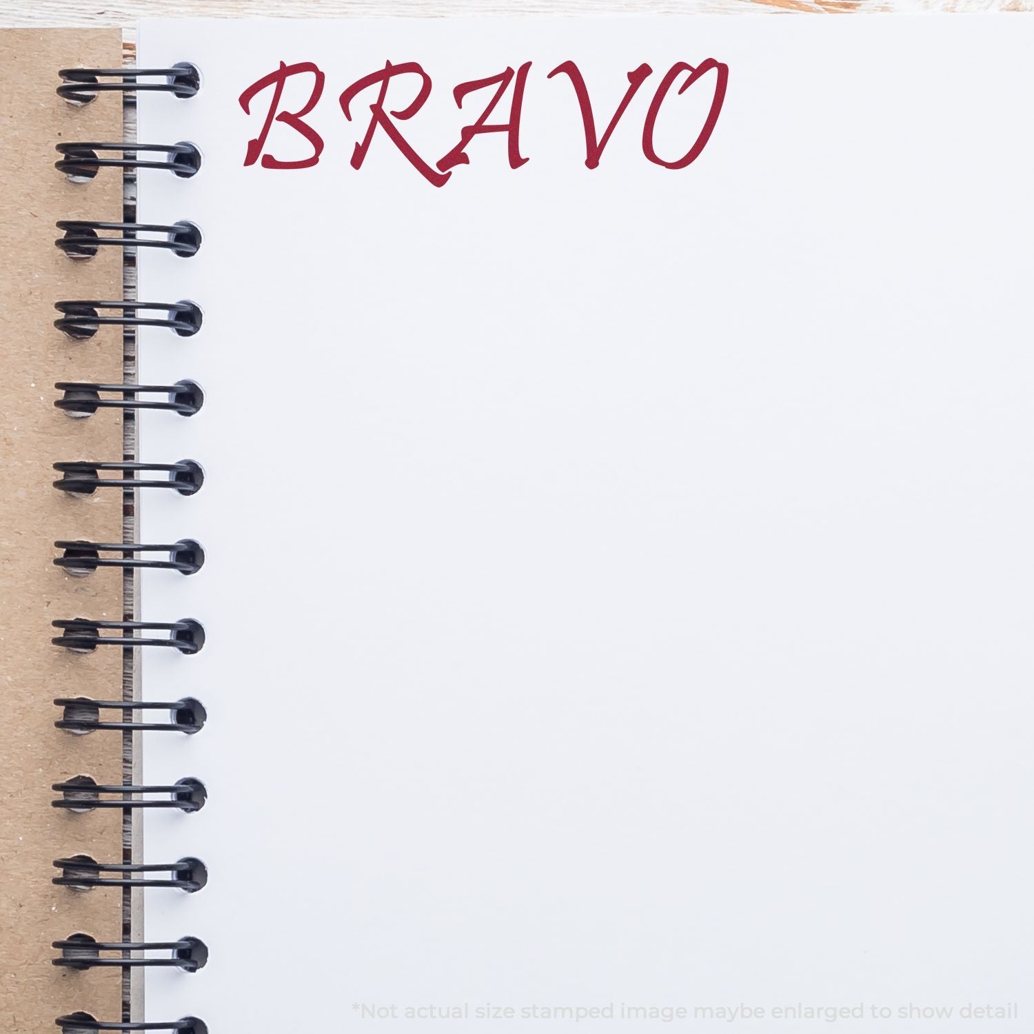 Stylized BRAVO text on a spiral notebook page, red decorative lettering on a blank white background.