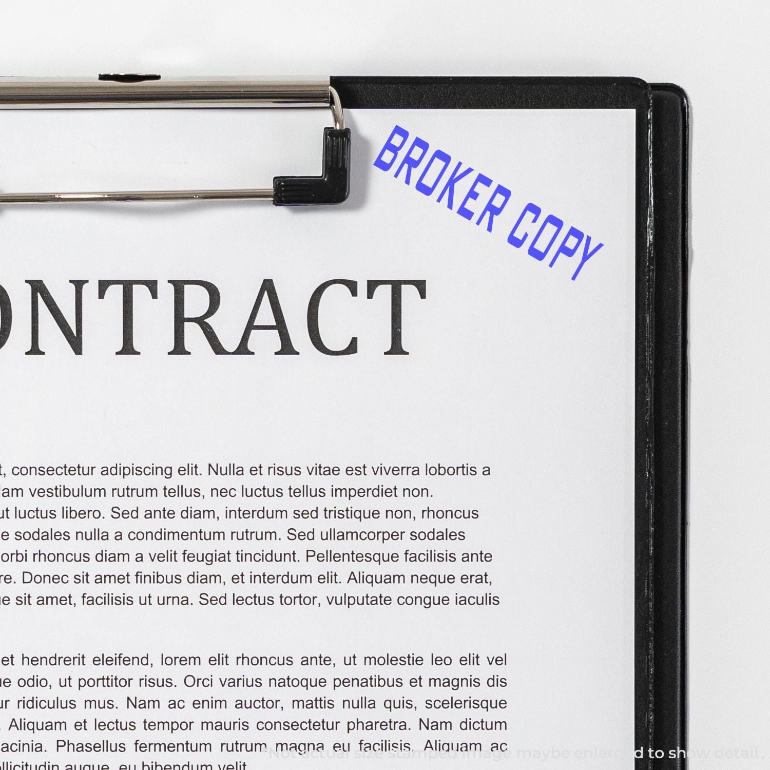 Clipboard showing BROKER COPY label on a contract document page, representing broker copy paperwork and agreement text.