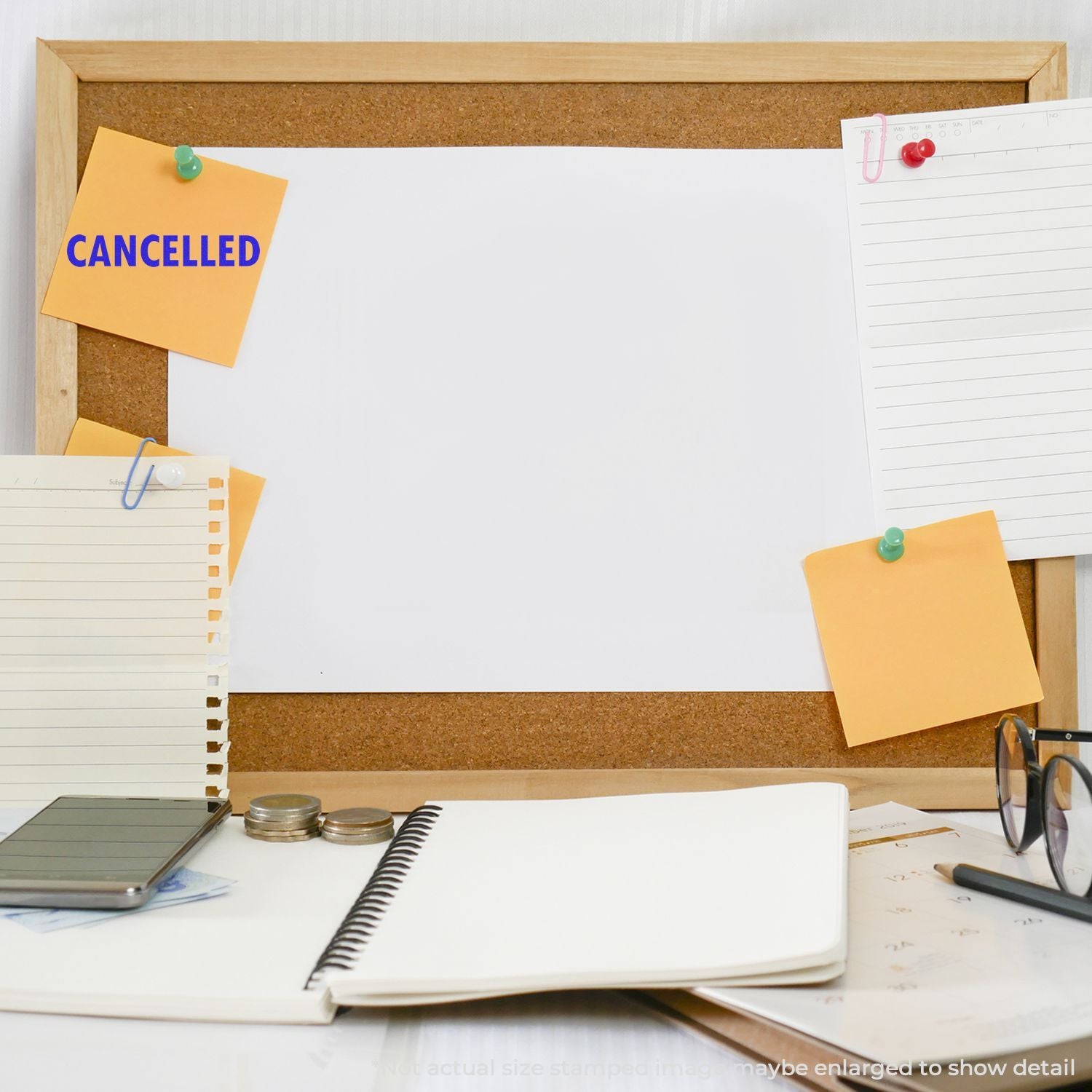 Office desk with corkboard and CANCELLED sticky note, calendar pages, and suppliesillustrating cancelled plans and scheduling changes.