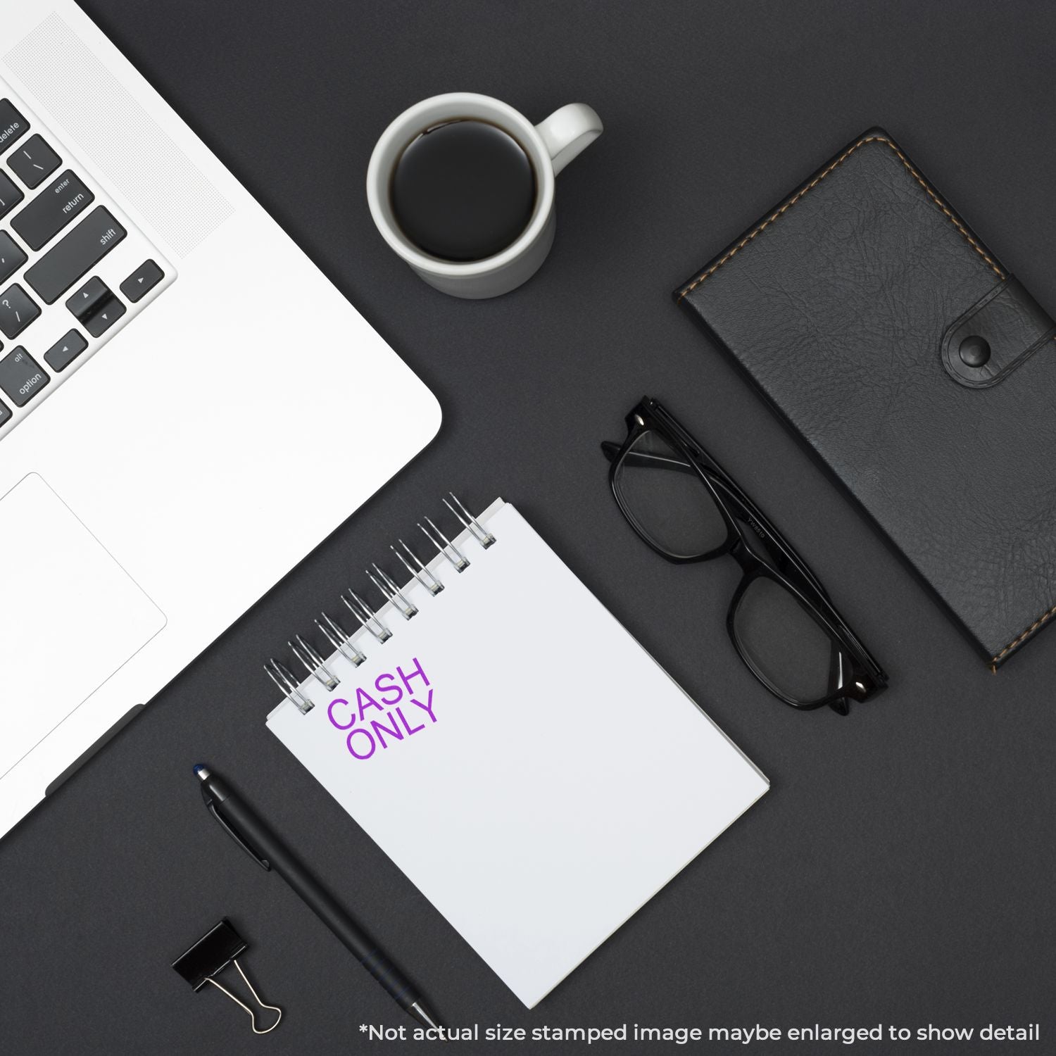 Minimal black office desk flat lay with laptop, coffee, notebook reading Cash Only, glasses, pen, and wallet on dark background.