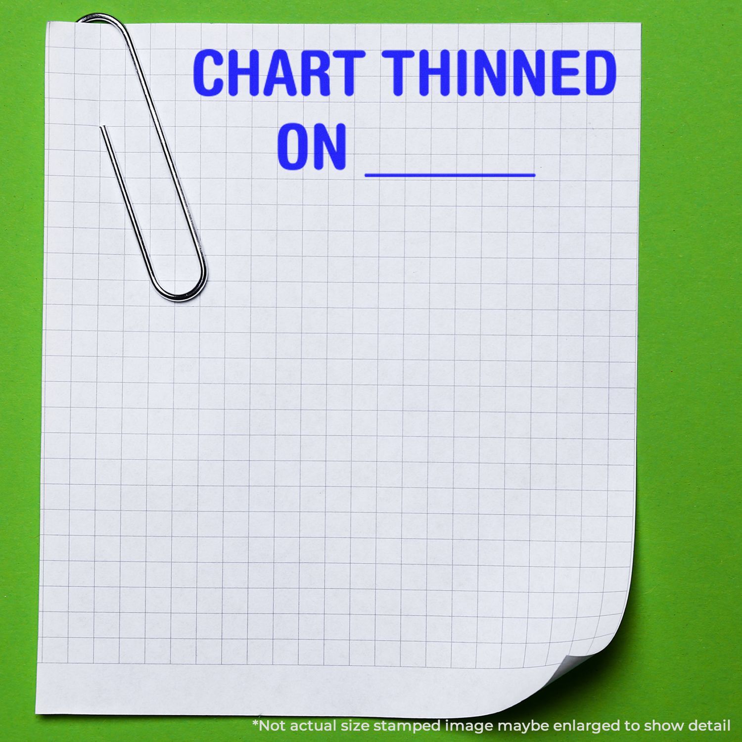Paper clip on graph paper with bold blue text CHART THINNED ON on green background.