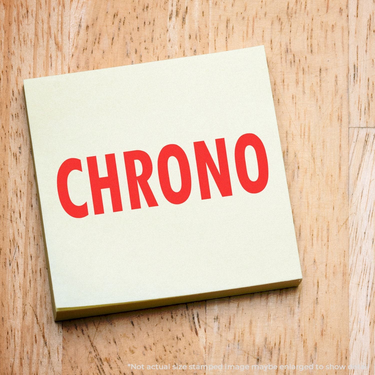 CHRONO word stamp in red on white card over rustic wood background, branding label for Chrono products and services logo signage