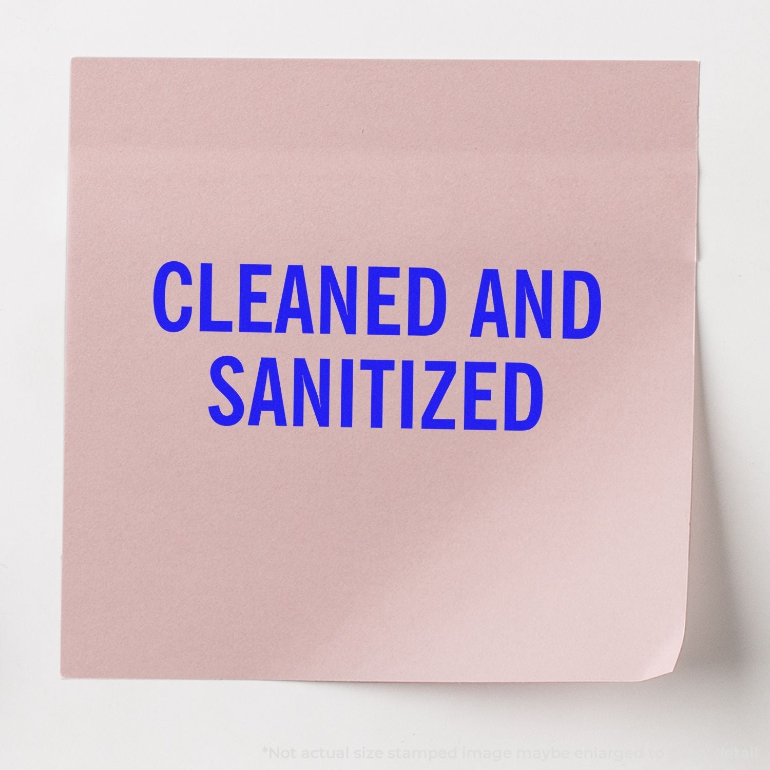 Pink paper sign with bold blue text reading CLEANED AND SANITIZED on a white background.