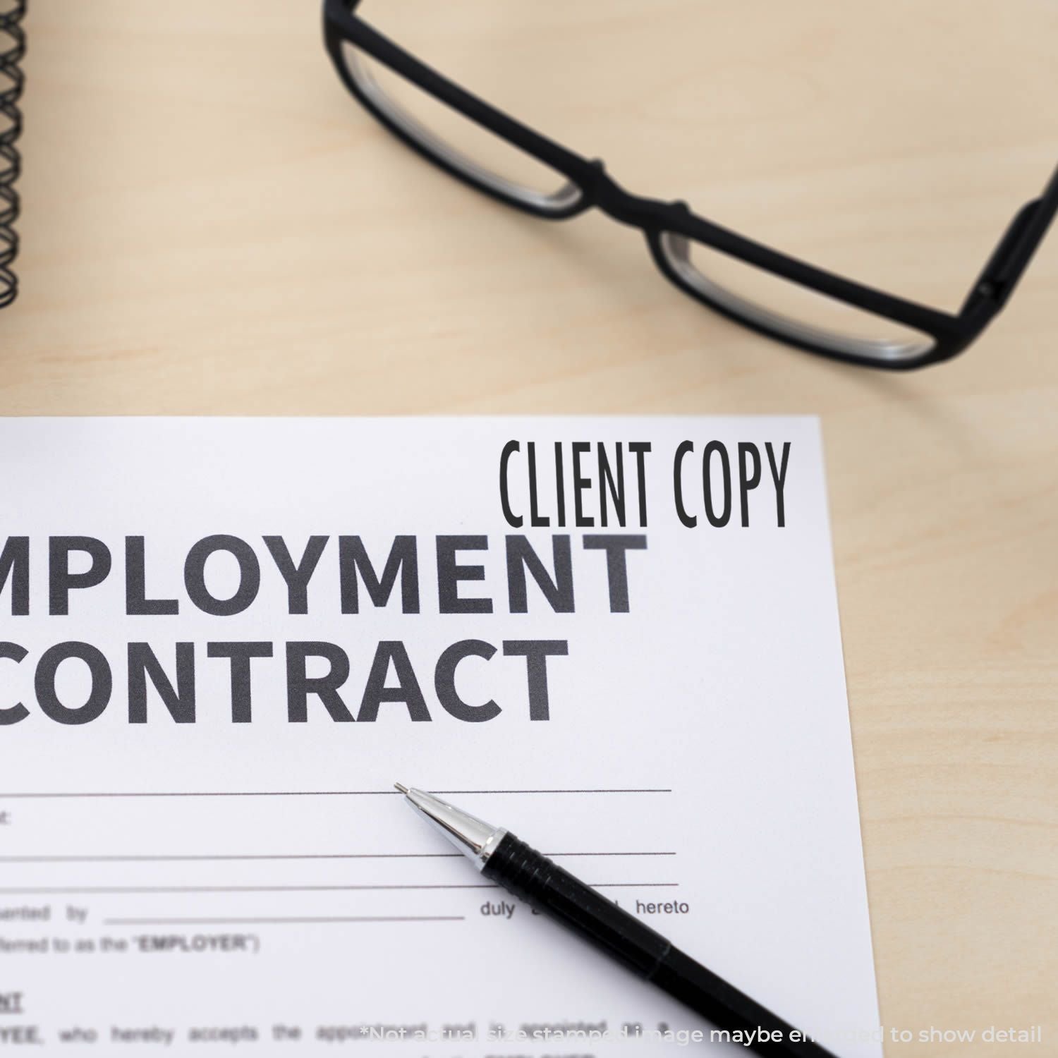Pen and CLIENT COPY employment contract document for signing, legal paperwork with client copy label.