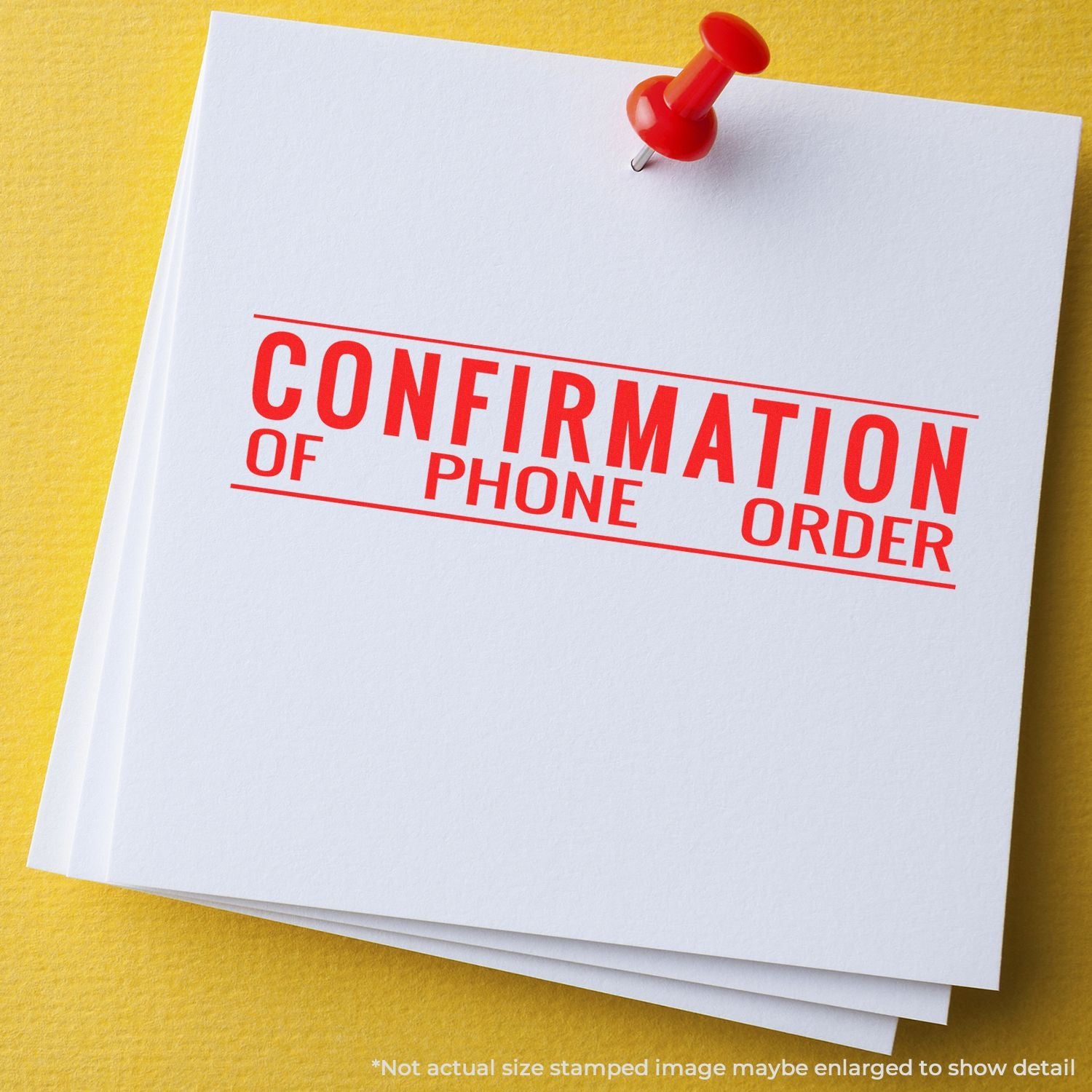 Confirmation of phone order stamped on white paper pinned with a red pushpin on a yellow background.