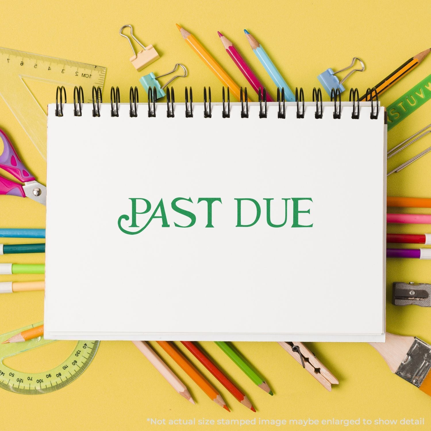 PAST DUE on a notebook with school supplies backgroundpencils, ruler, paper clipsstudy reminder flat lay