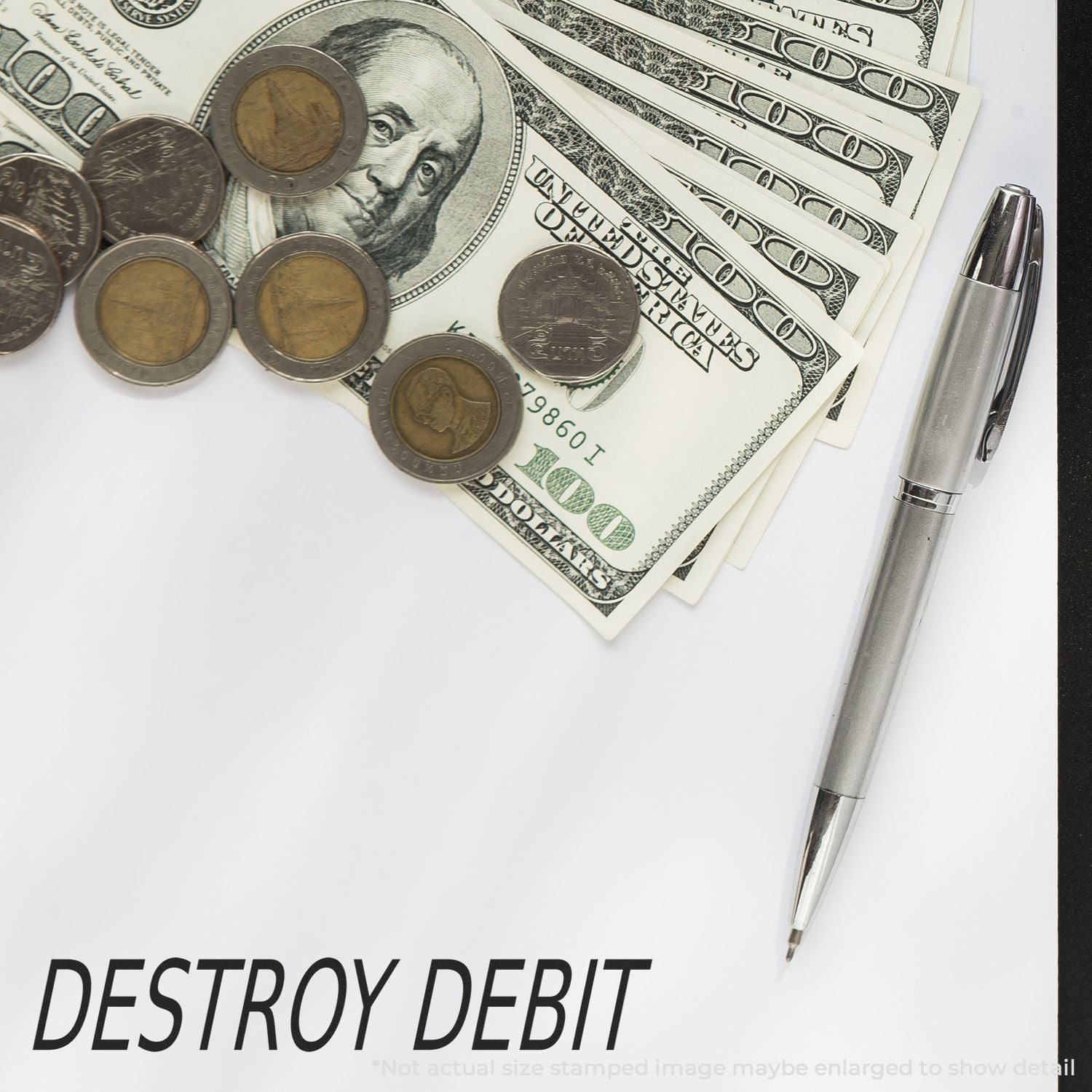 Close-up of US dollar bills, coins, and a pen on a paper with DESTROY DEBIT, symbolizing debt reduction and financial planning.
