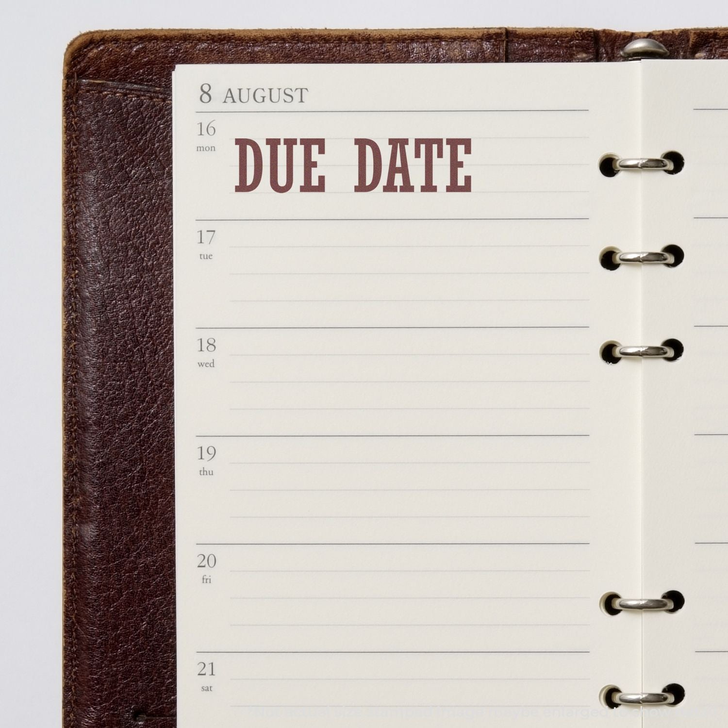 Open planner calendar on 8 August with bold DUE DATE label over the week of 16, showing notebook rings for deadline tracking.