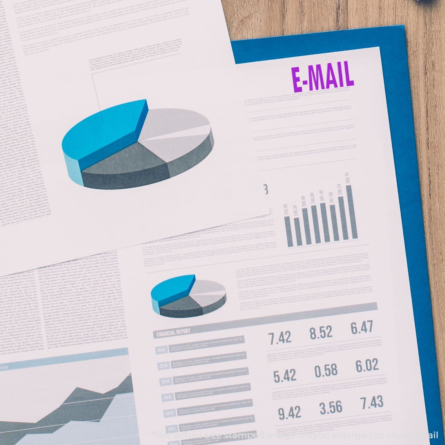 Email marketing and financial report with pie charts, bar graphs, and analytics documents on a wooden desk.