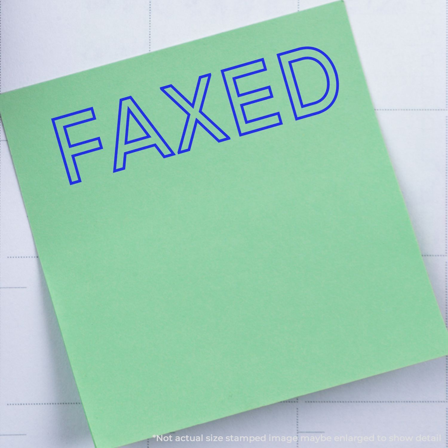 Green sticky note with blue FAXED text on a grid paper background.
