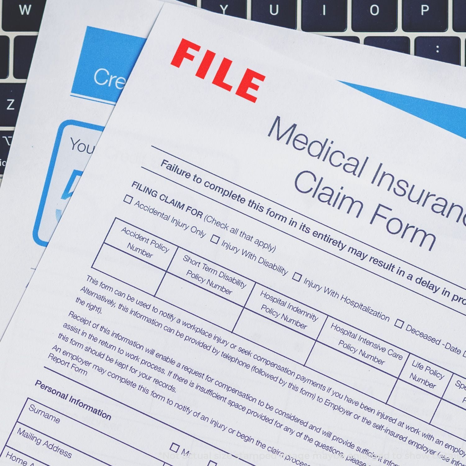 Medical insurance claim form paperwork on laptop keyboard, concept of filing a health insurance claim and reimbursement.