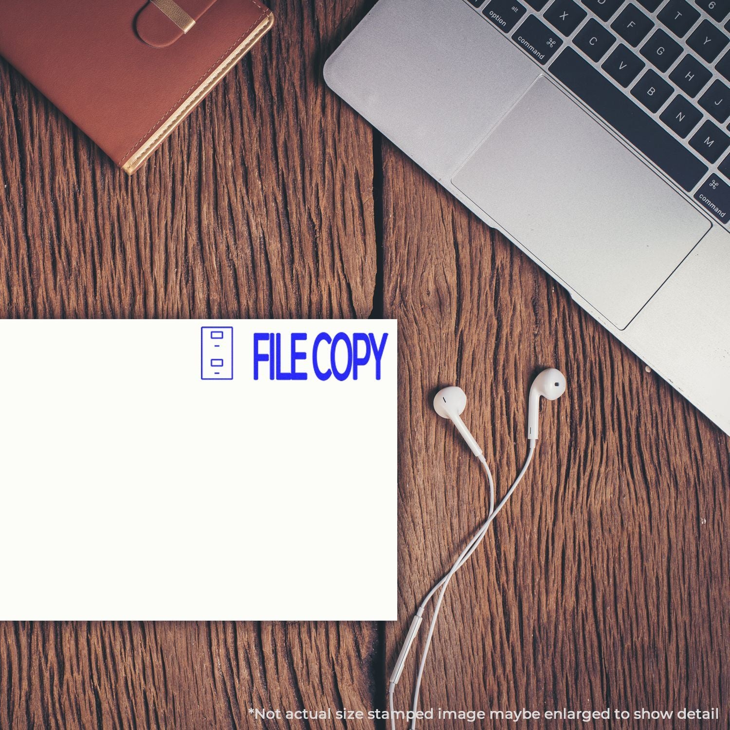 Top view of laptop, earphones, and file copy business card on a rustic wooden desk