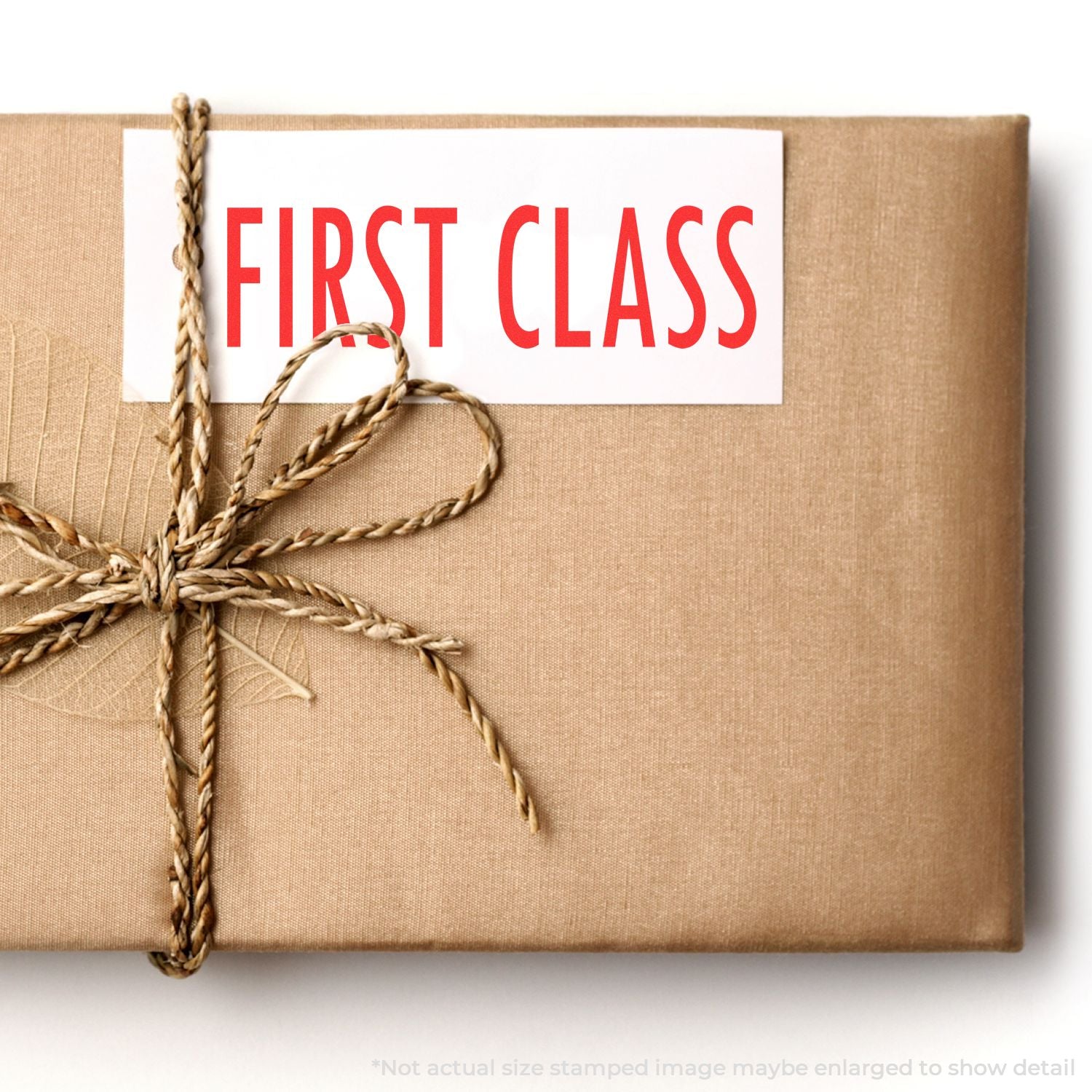 First Class shipping label on a tied kraft package, representing premium delivery and mail services
